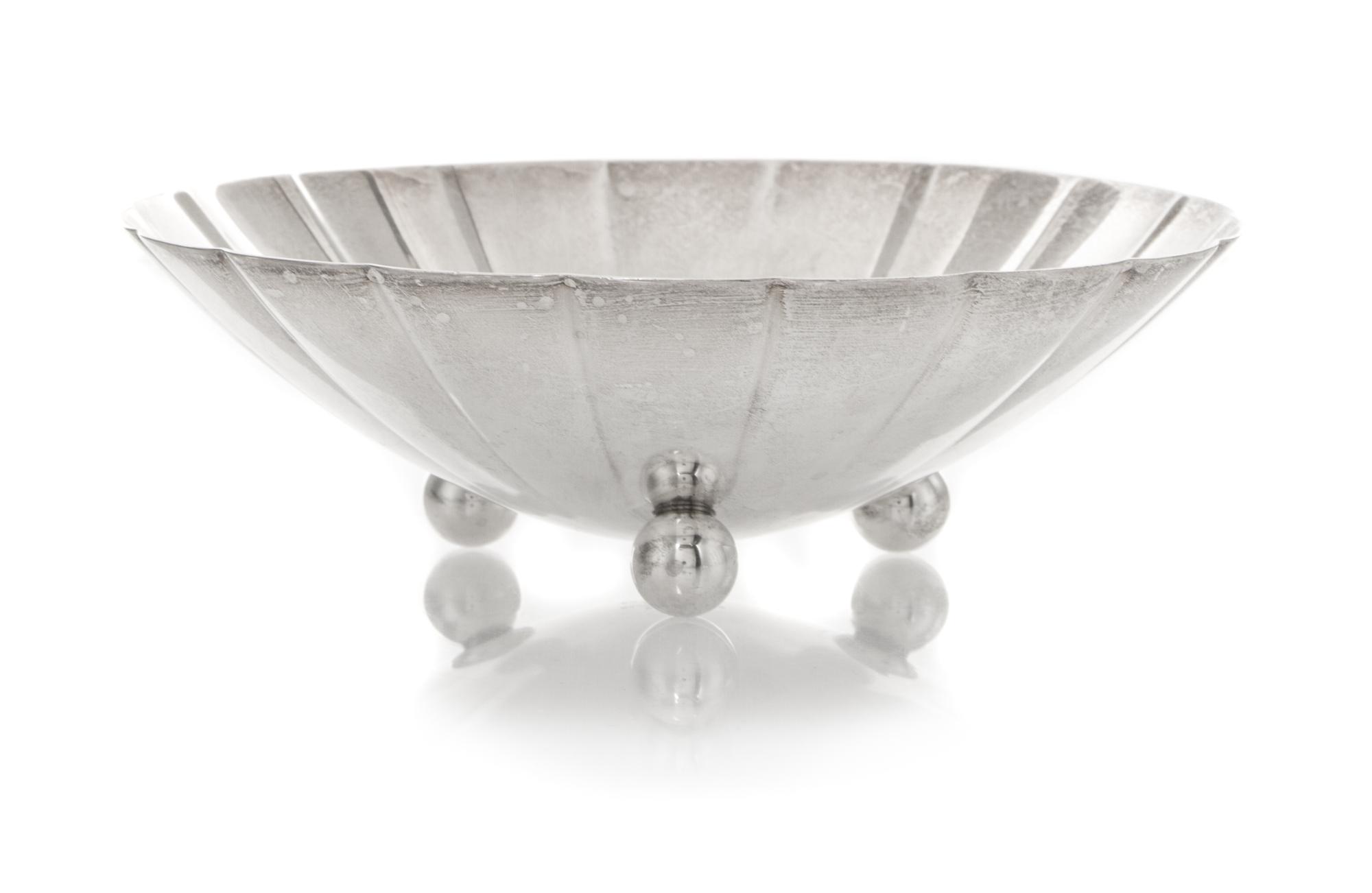 An American Silver Small Bowl, Tiffany & Co., New York, NY, 1940, circular with scalloped sides, raised on three ball feet, engraved in