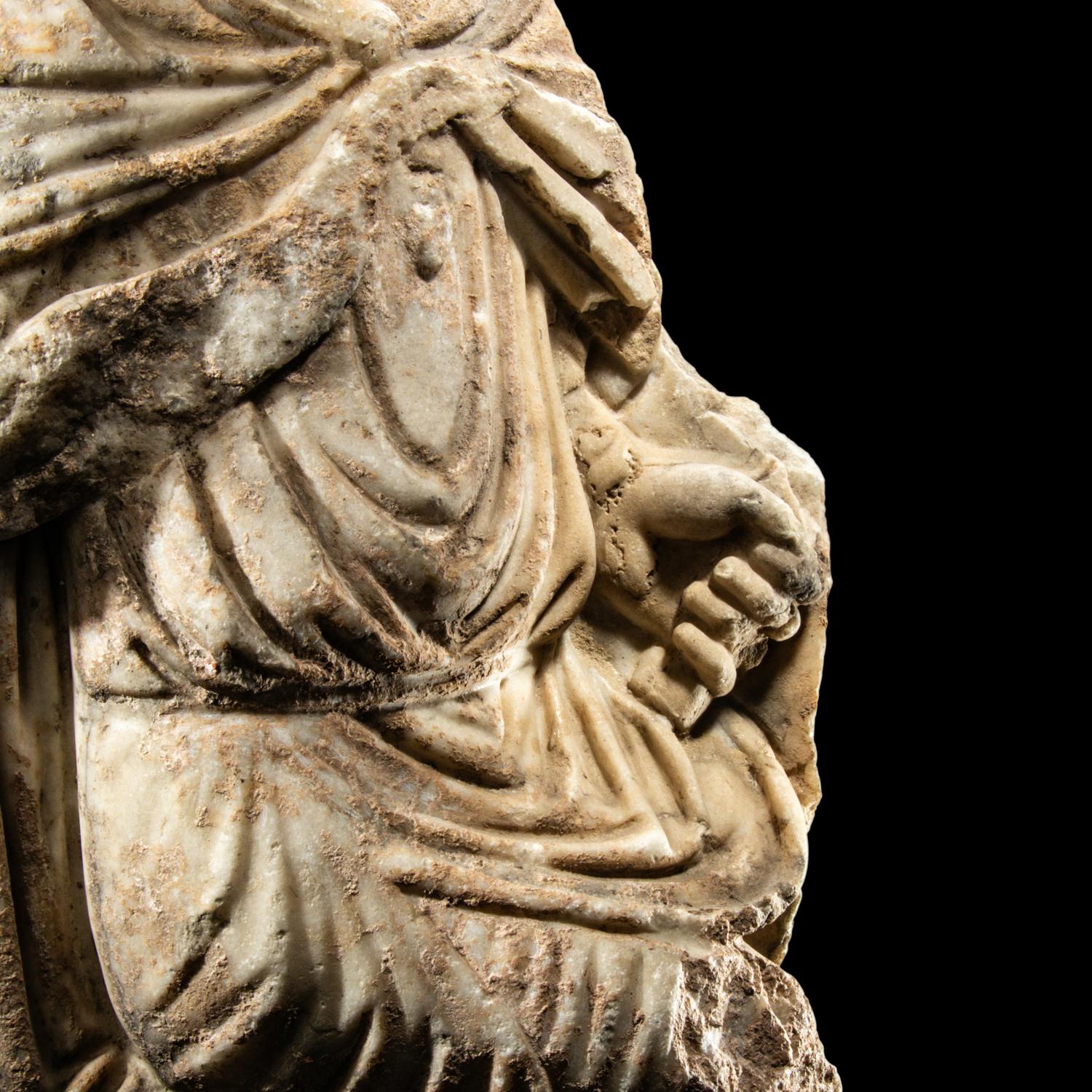 A Roman Marble Fragment of a Seated Offical