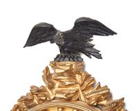 A Regency Giltwood and Part Ebonized Bull's Eye Mirror