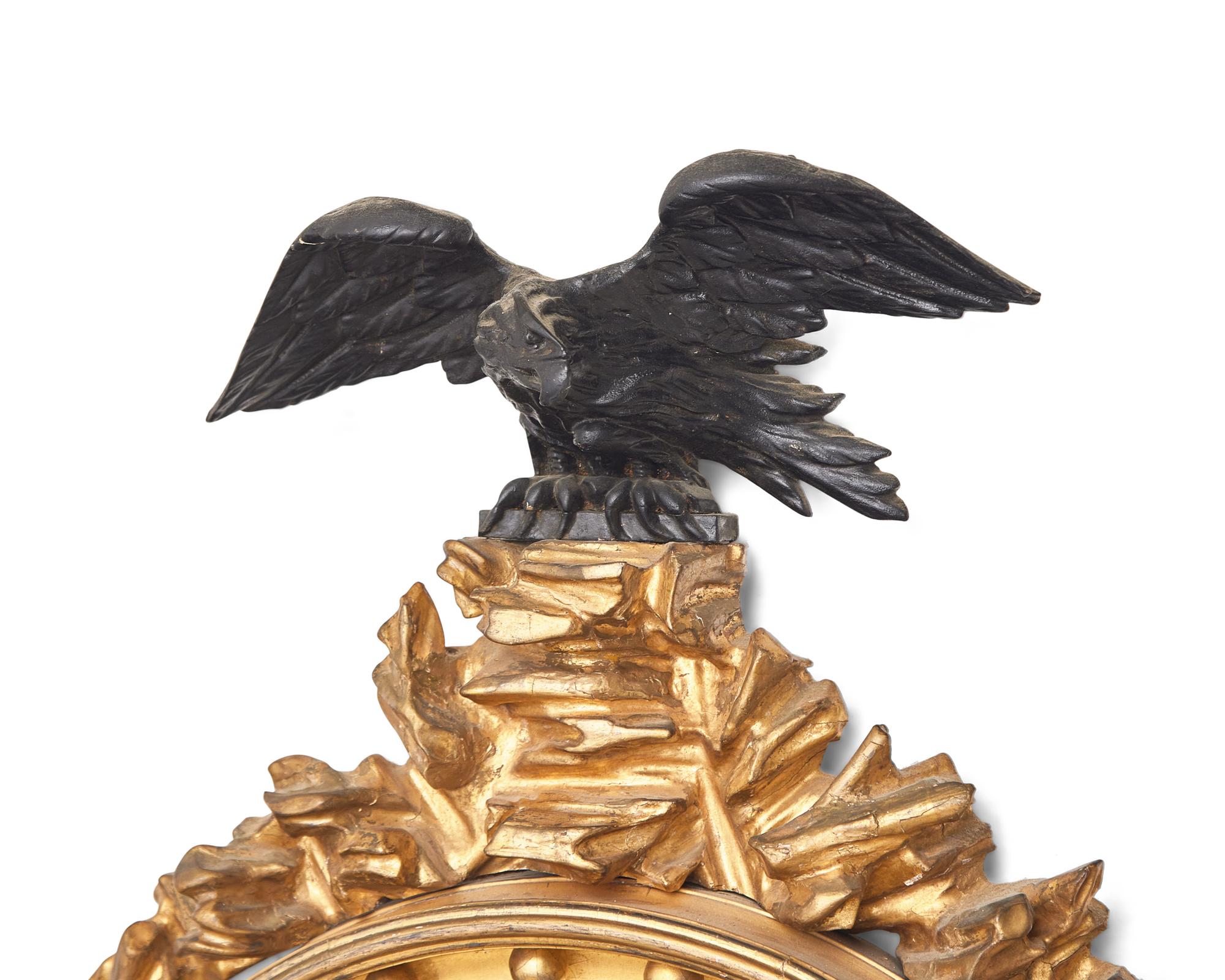 A Regency Giltwood and Part Ebonized Bull's Eye Mirror