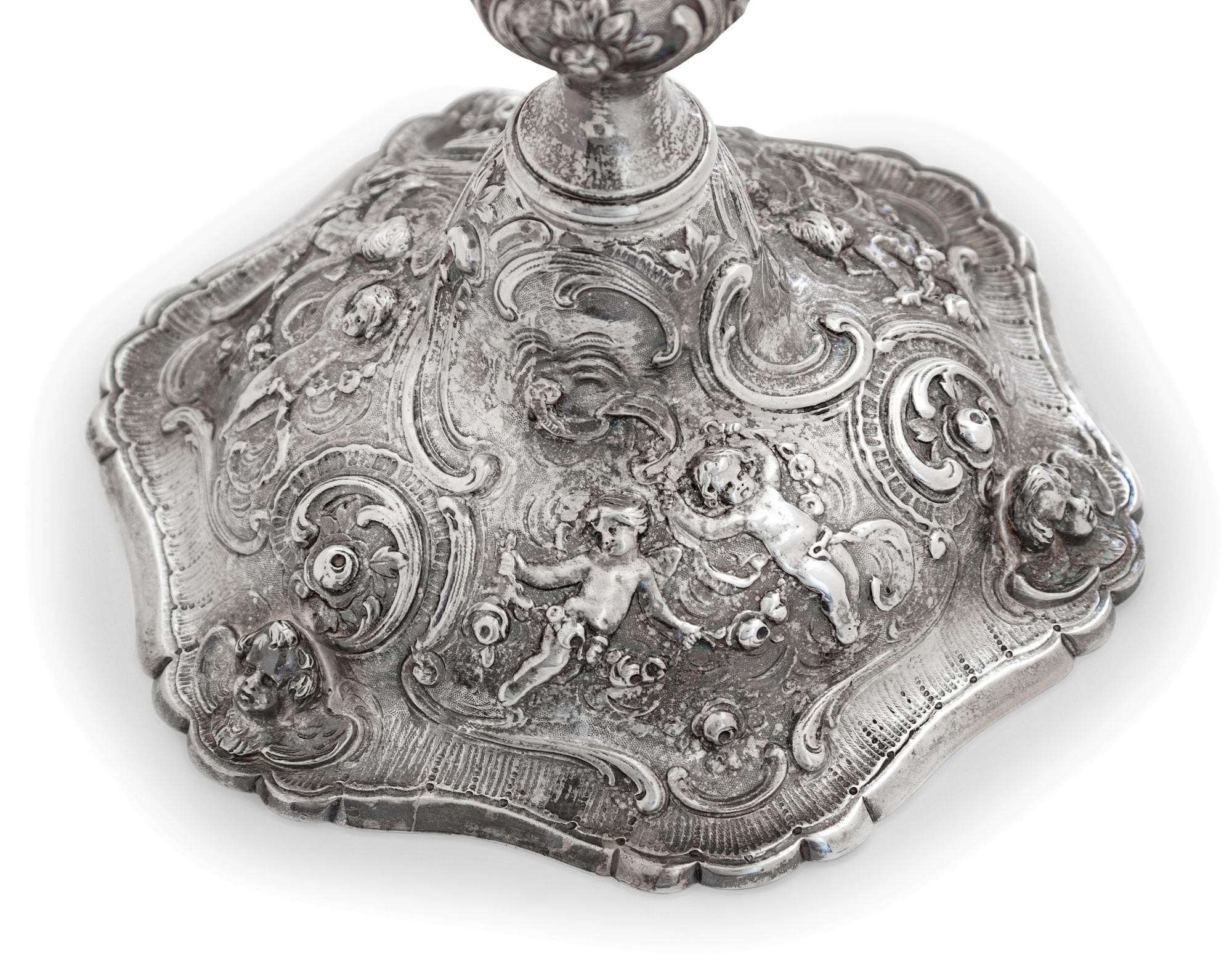 A Set of Four Rococo Revival Silver Candlesticks