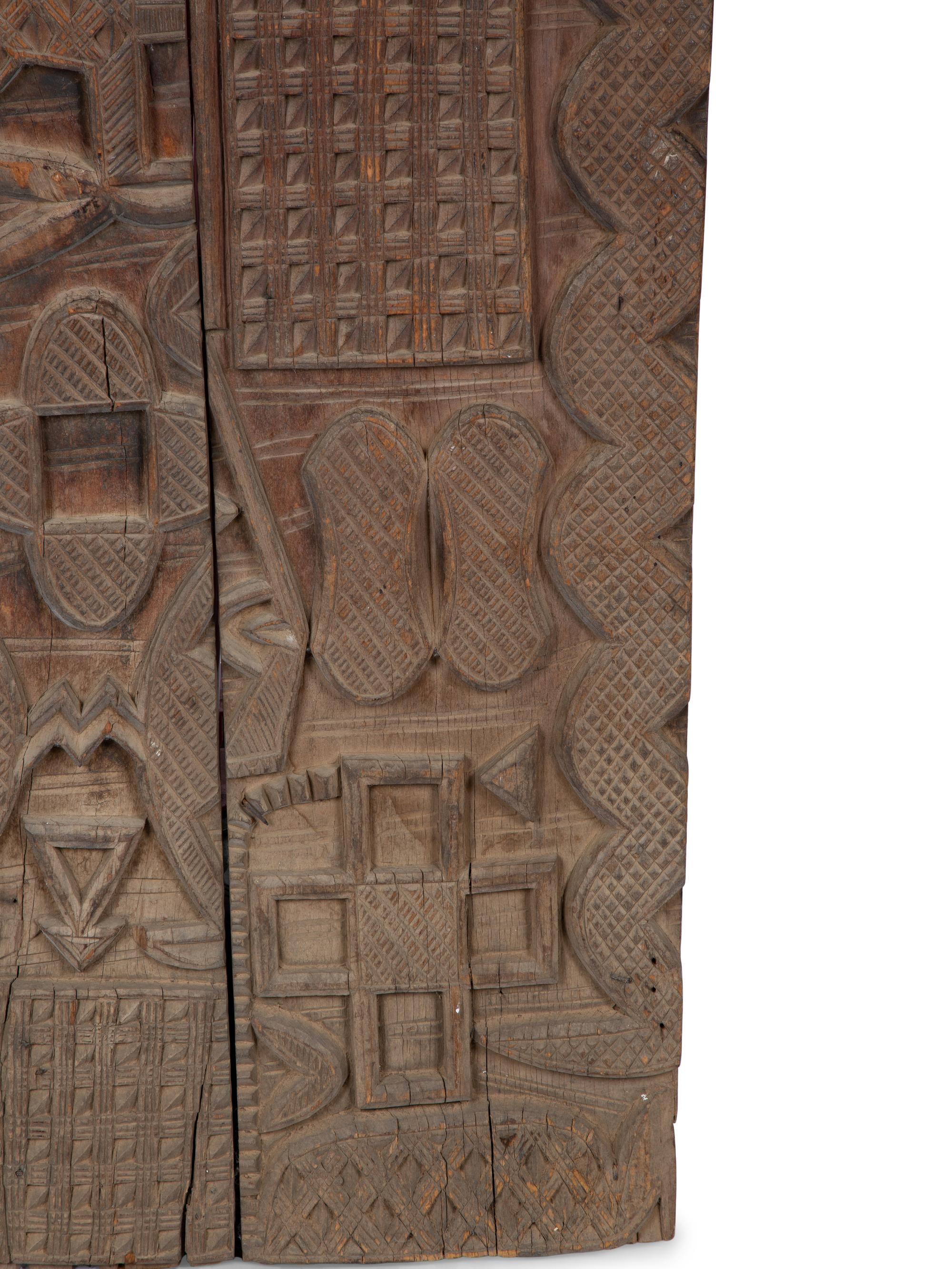 An African Carved Wood Panel — 20TH CENTURY