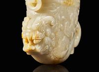 A large Chinese carved pale celadon and russet jade rhyton vessel 青白玉雕觥杯