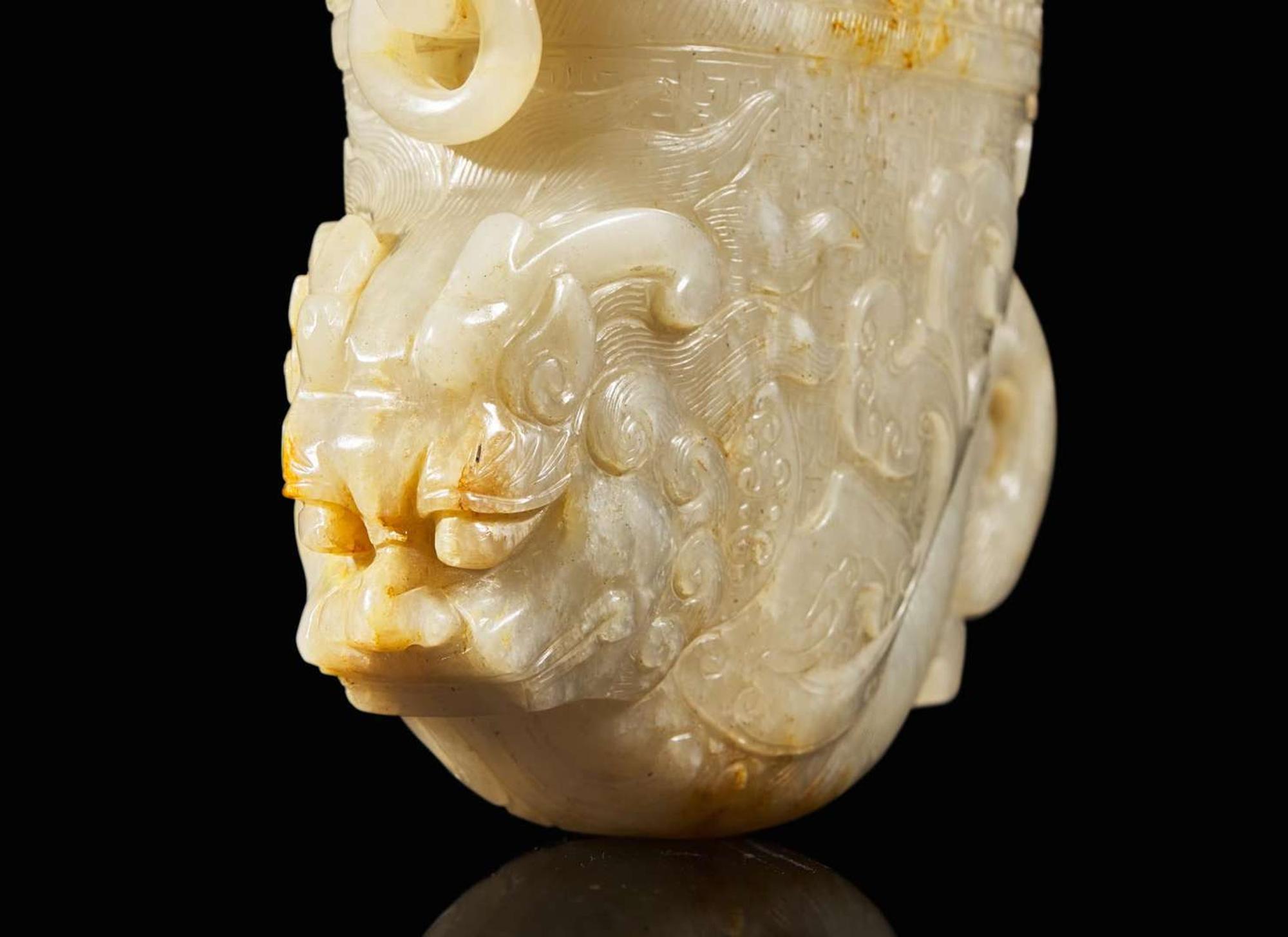 A large Chinese carved pale celadon and russet jade rhyton vessel 青白玉雕觥杯