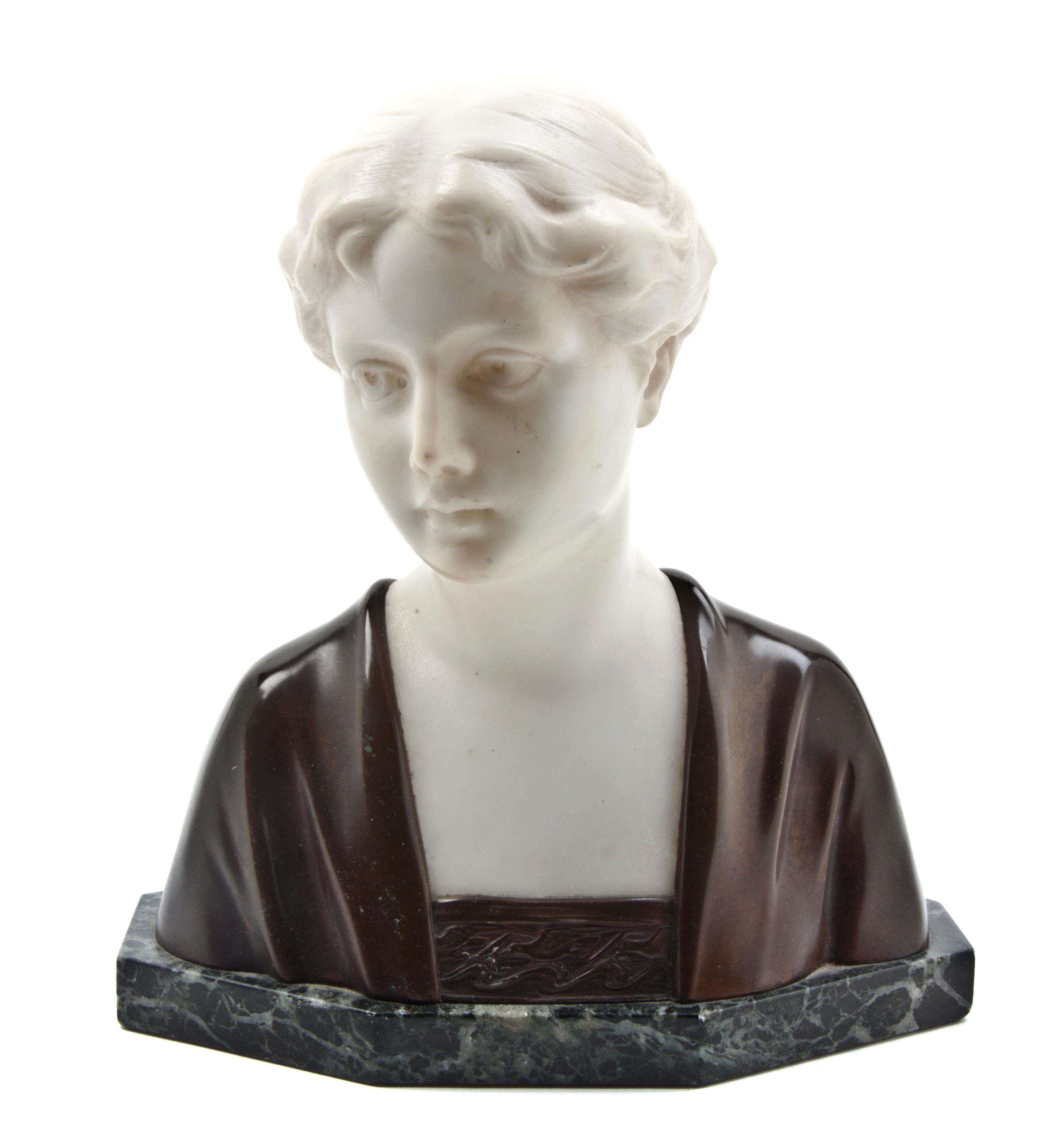A Bronze and Marble Bust, Height 7 1/2 inches.