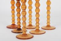 A Set of Fifteen St. Louis Amber Glass Stems