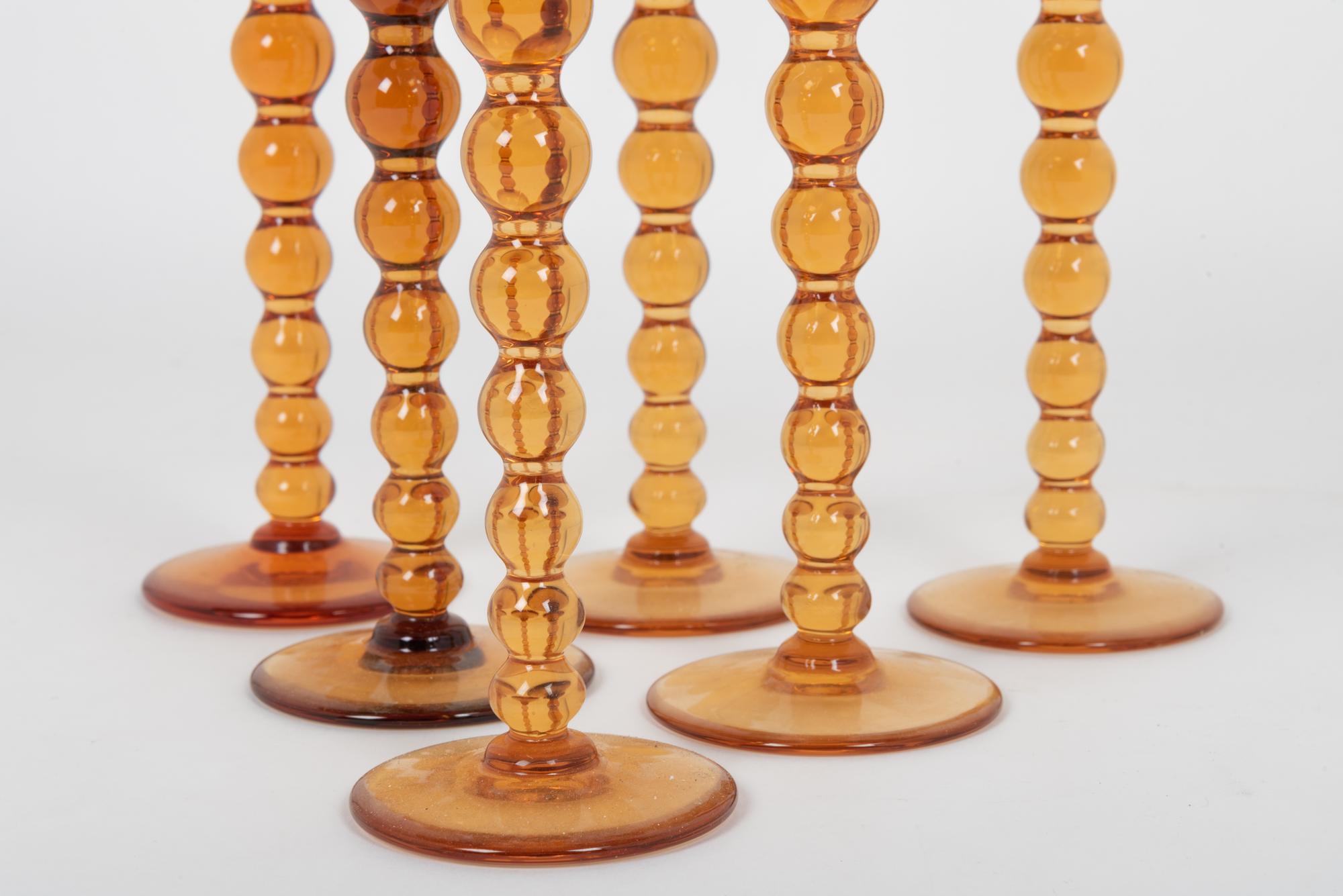 A Set of Fifteen St. Louis Amber Glass Stems