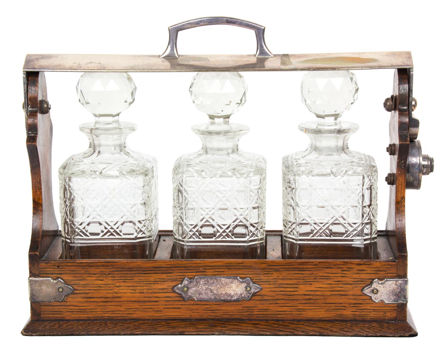 An English Silver Plate Mounted Oak Tantalus Height 11 1/4 x length 13 3/4 inches. — 19TH CENTURY