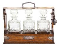 An English Silver Plate Mounted Oak Tantalus Height 11 1/4 x length 13 3/4 inches. — 19TH CENTURY