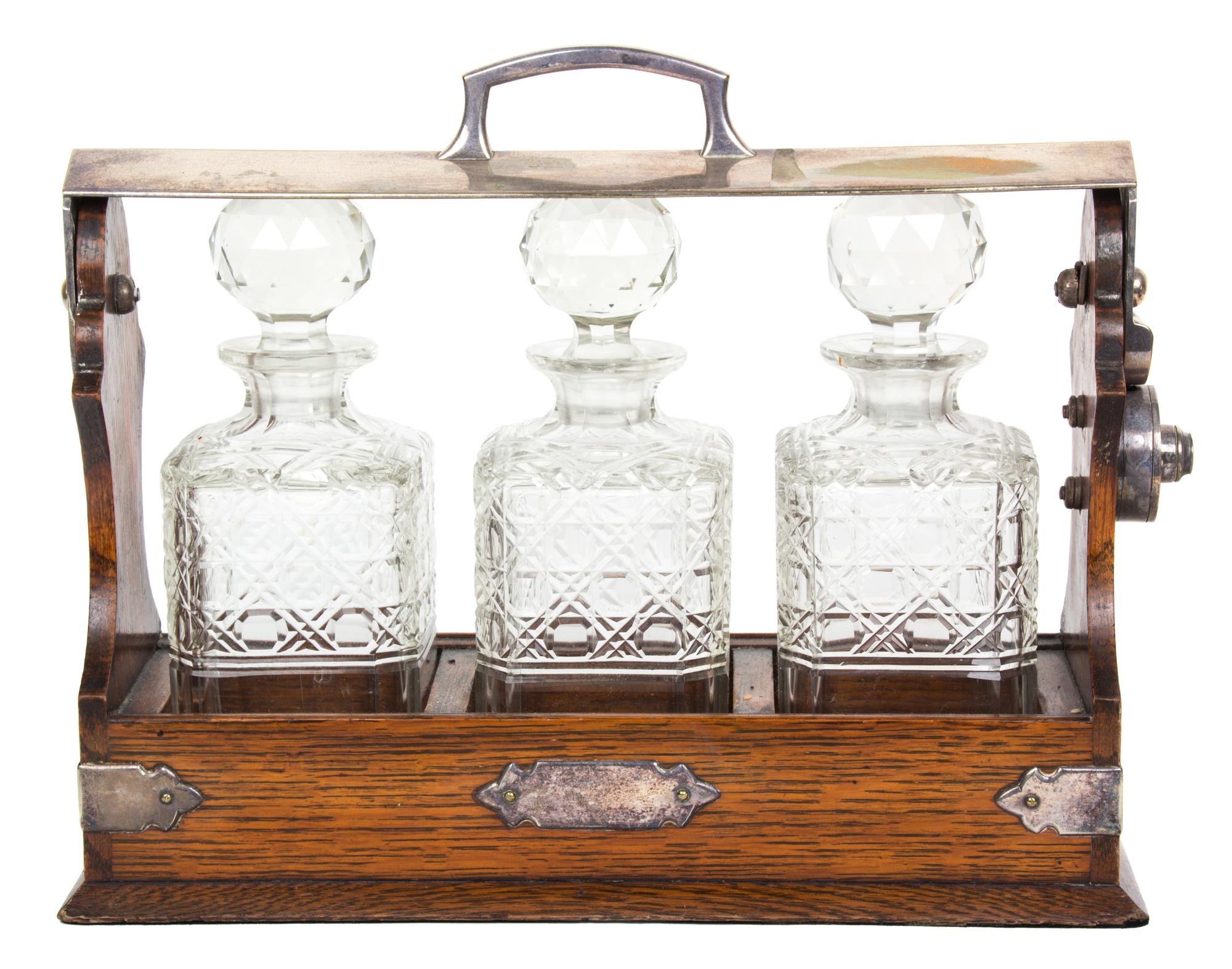 An English Silver Plate Mounted Oak Tantalus Height 11 1/4 x length 13 3/4 inches. — 19TH CENTURY