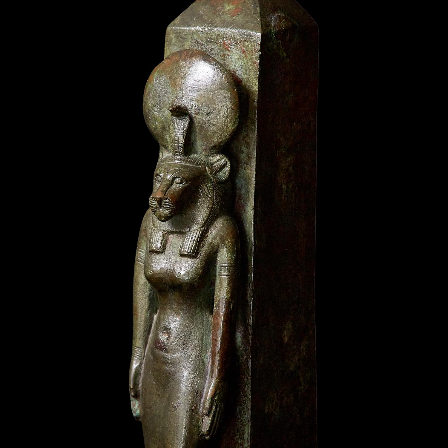 An Egyptian Bronze Lion-Headed Goddess and Obelisk