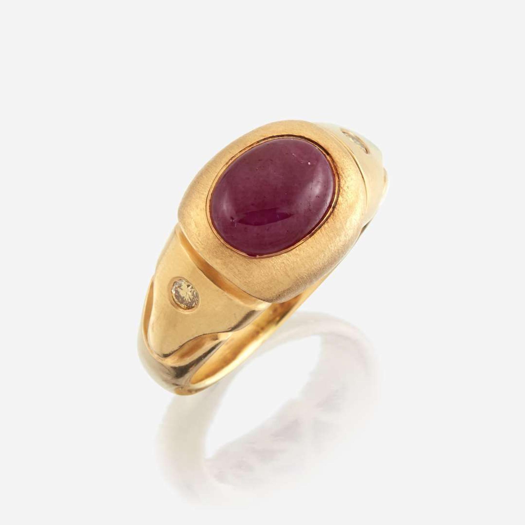 A twenty-two karat gold, ruby, and colored diamond ring