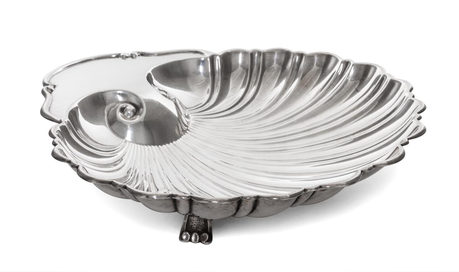 An American Silver Dish, Fisher Silversmiths, Newark, NJ, Mid-20th Century, formed as a shell and raised on three scroll supports.