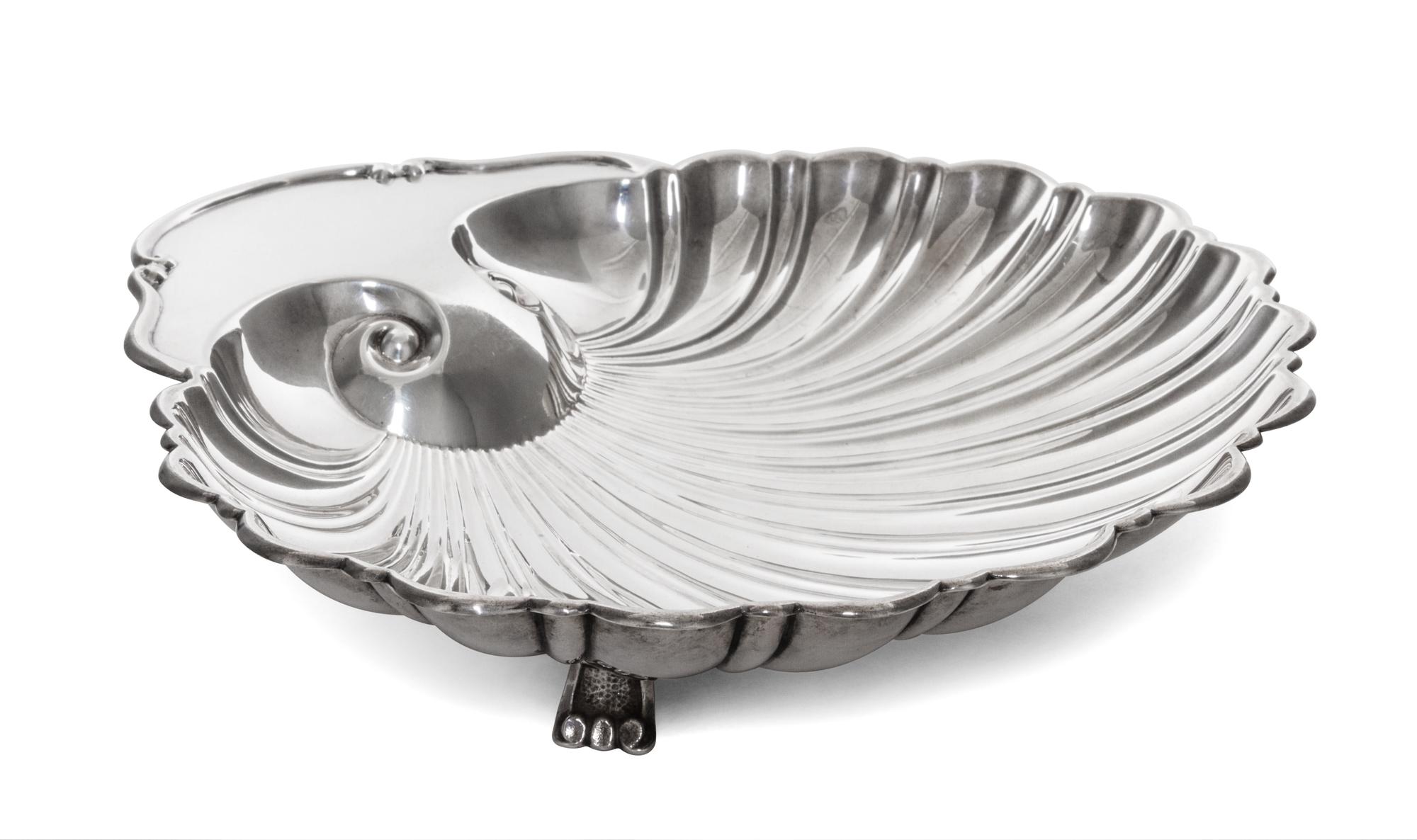 An American Silver Dish, Fisher Silversmiths, Newark, NJ, Mid-20th Century, formed as a shell and raised on three scroll supports.