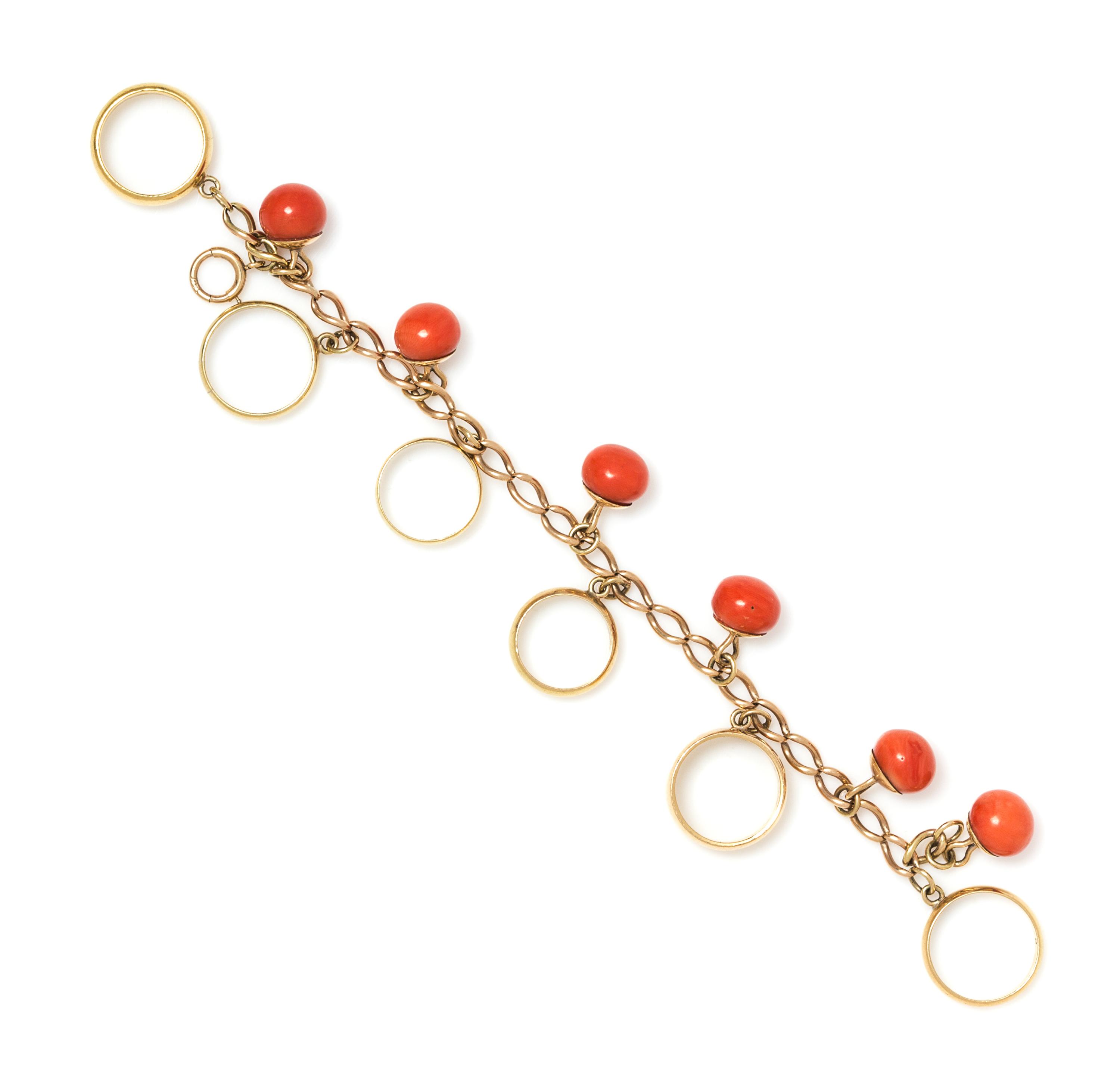 A Victorian Yellow Gold Ring, Coral Bead and Wedding Ring Charm Bracelet, 33.70 dwts.