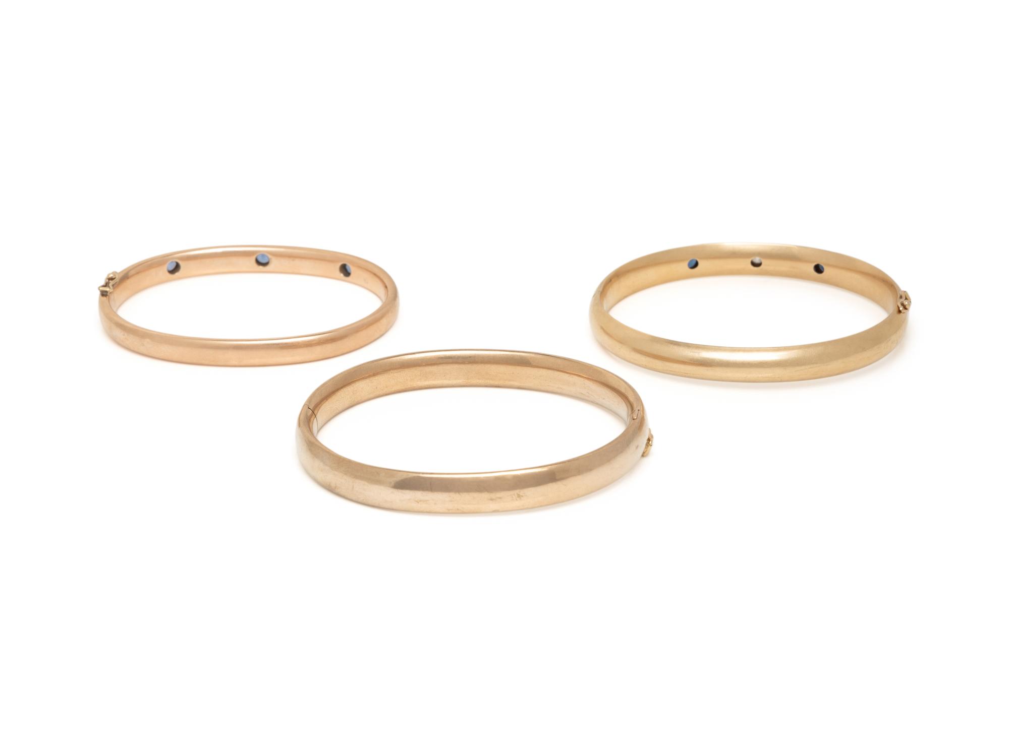 COLLECTION OF YELLOW GOLD, SAPPHIRE, AND DIAMOND BANGLE BRACELETS