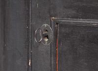 A Chippendale black-painted pine hanging corner cupboard, late 18th century