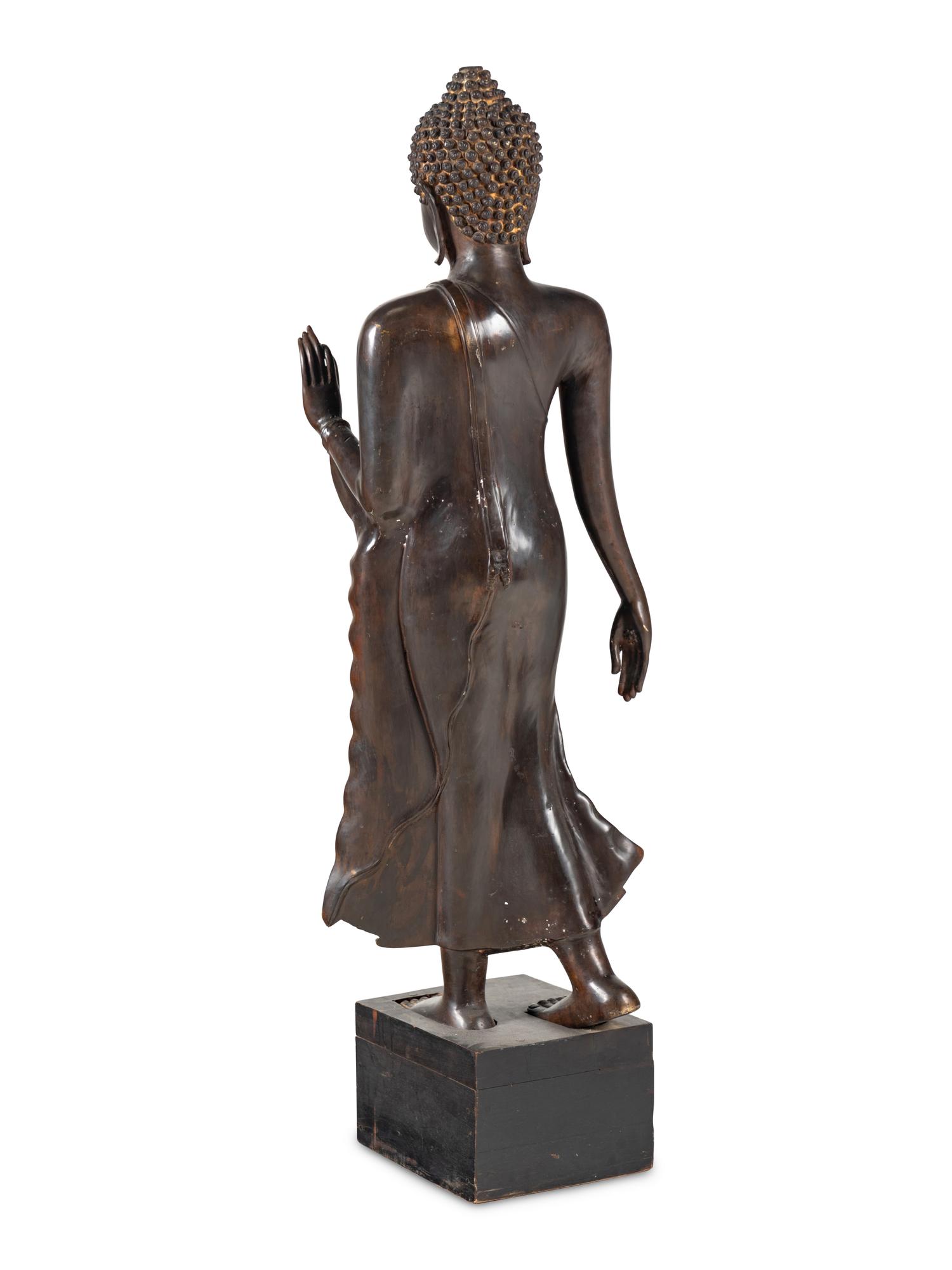 A Large Thai Bronze Figure of Walking Buddha