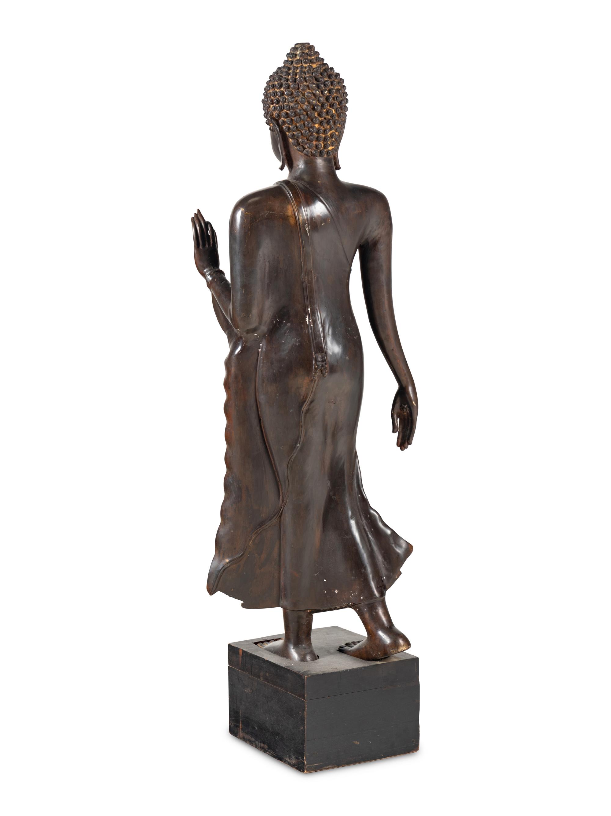 A Large Thai Bronze Figure of Walking Buddha