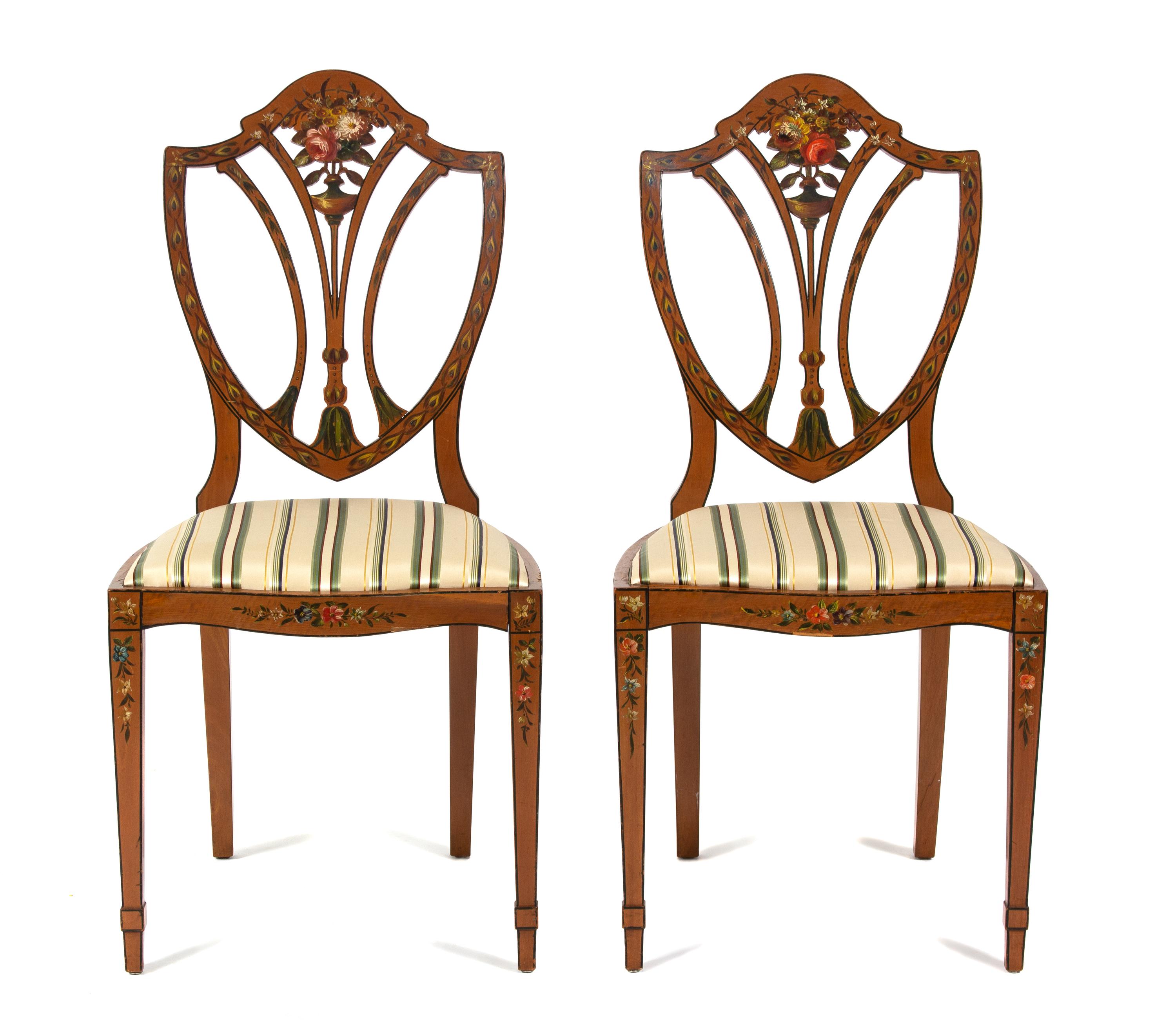 A Pair of Polychrome Floral Painted Satinwood Chairs Height 36 x width 18 x depth 15 1/2 inches.