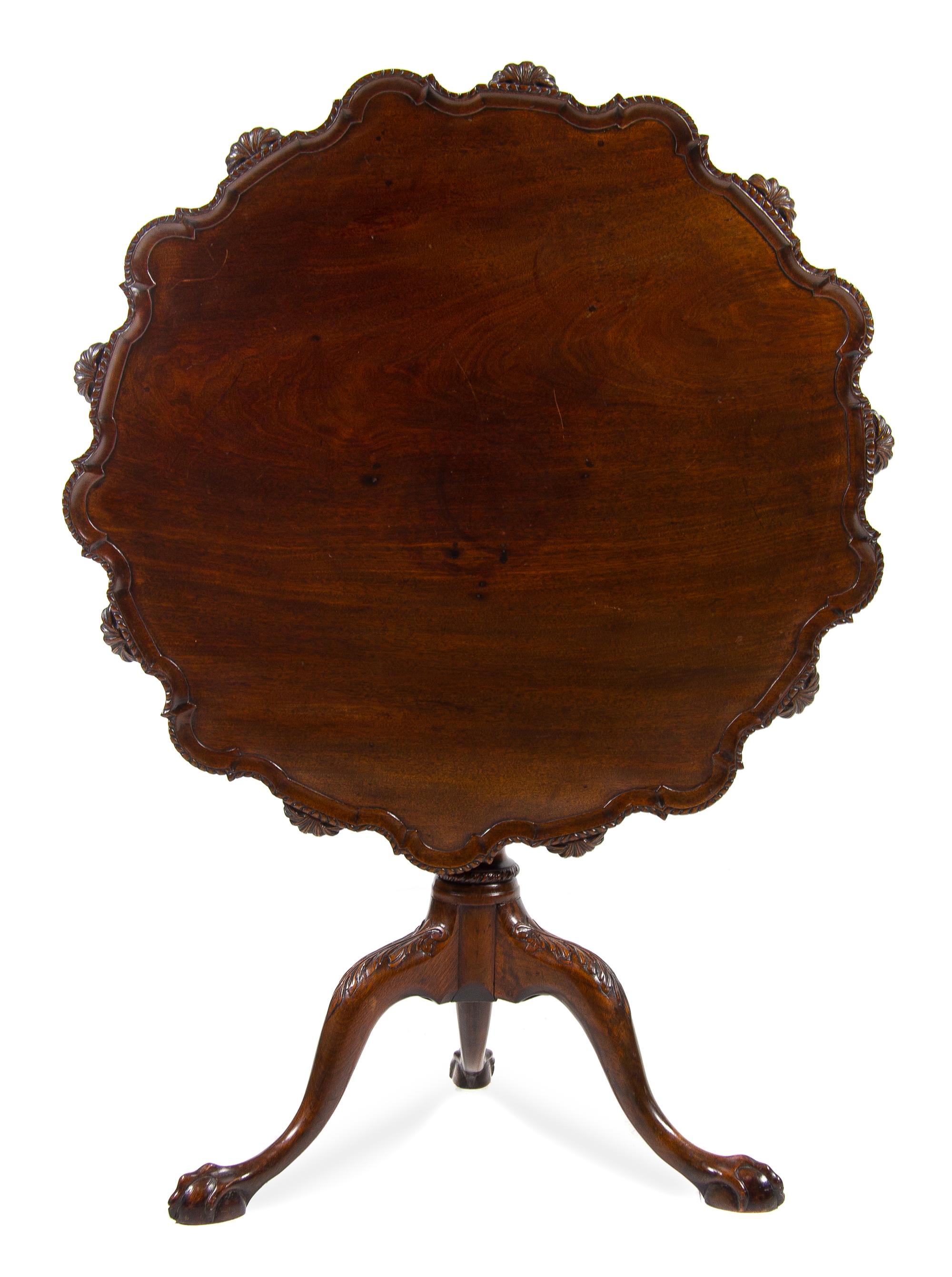 A George III Carved Mahogany Tilt-Top Occasional Table Diameter of top 34 inches. — 19TH CENTURY