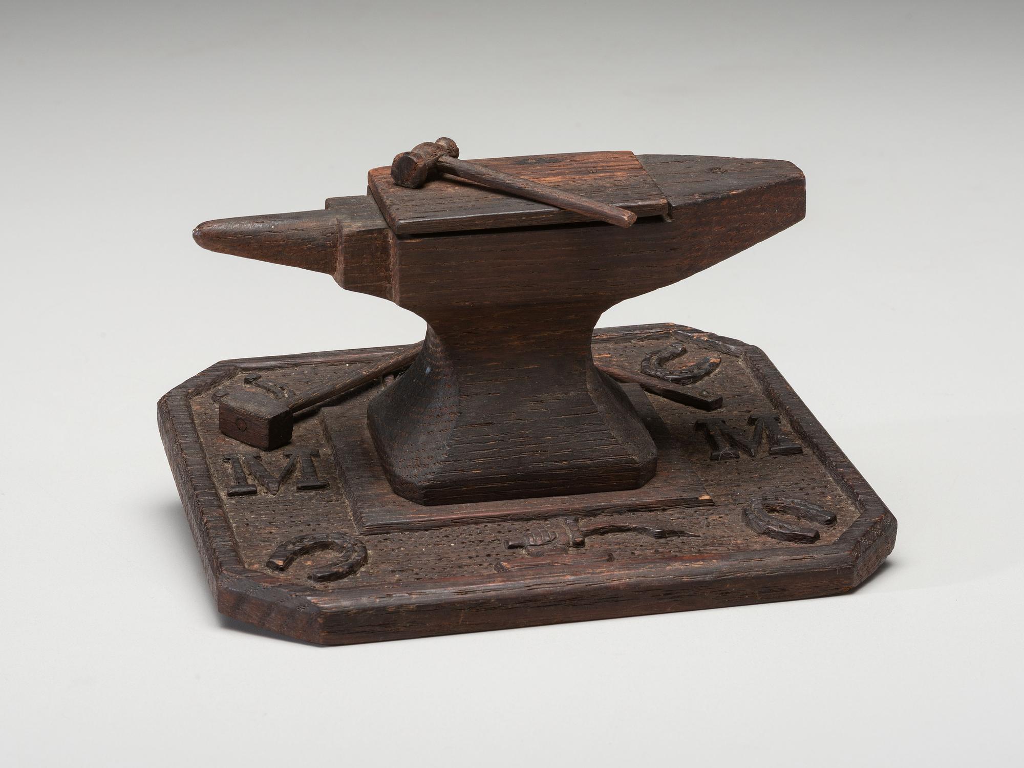 A Folk Art Carved and Stained Wood Anvil and Hammer Form Box