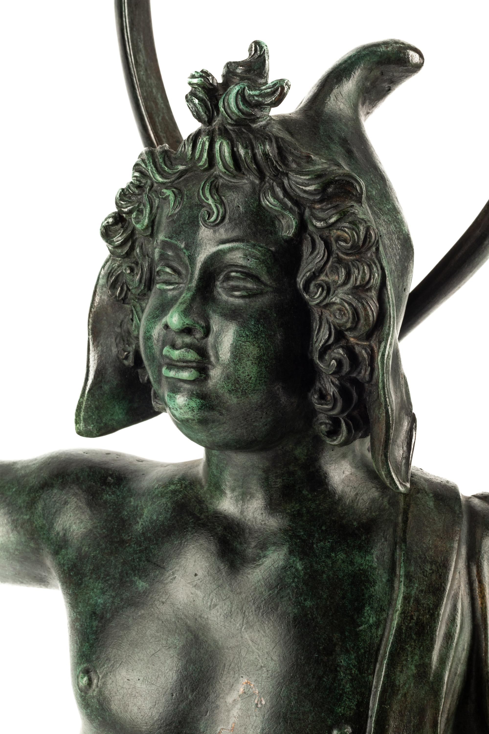 A Continental Patinated Bronze Figure with a Rock Crystal Ornament