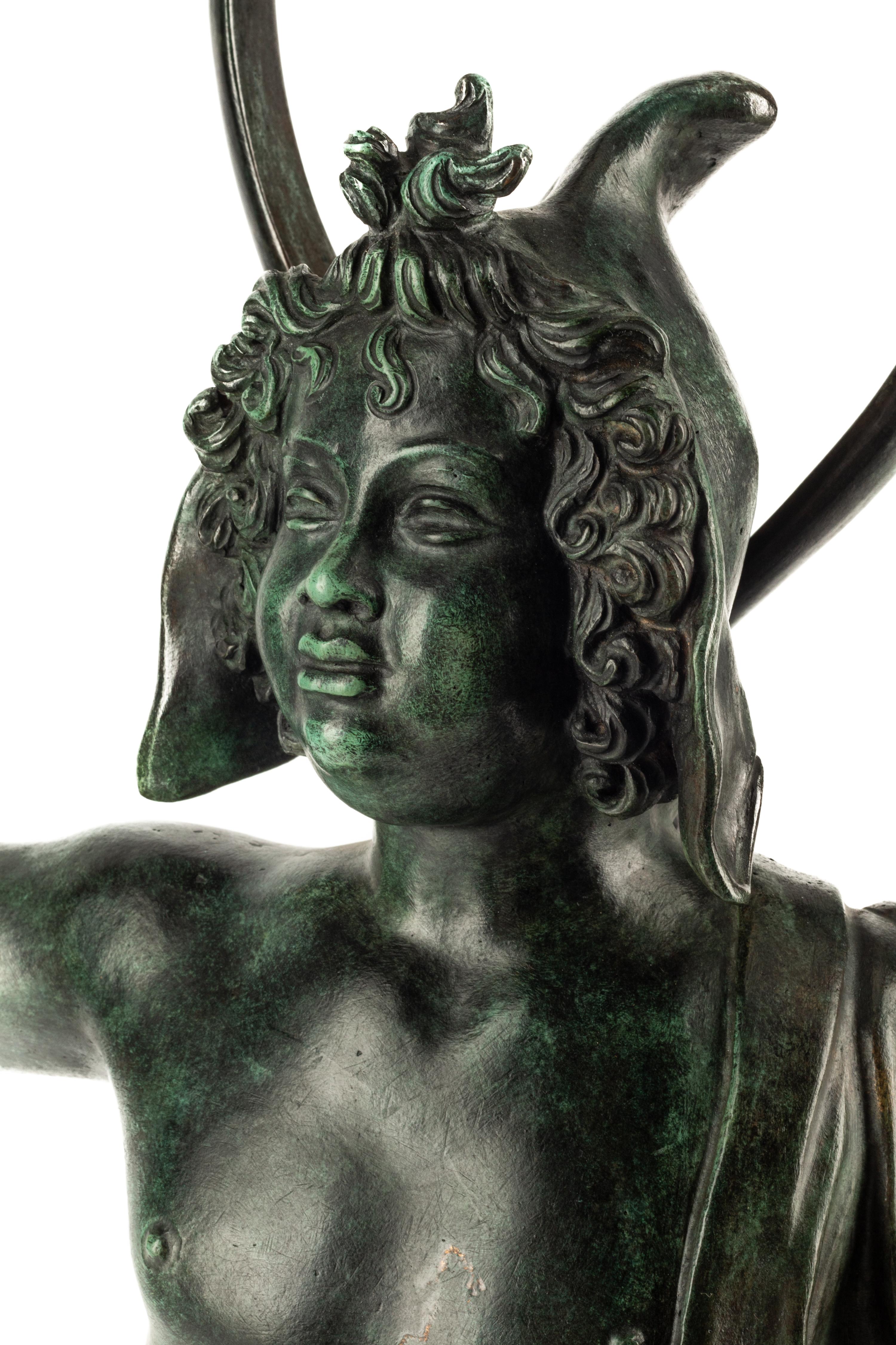 A Continental Patinated Bronze Figure with a Rock Crystal Ornament