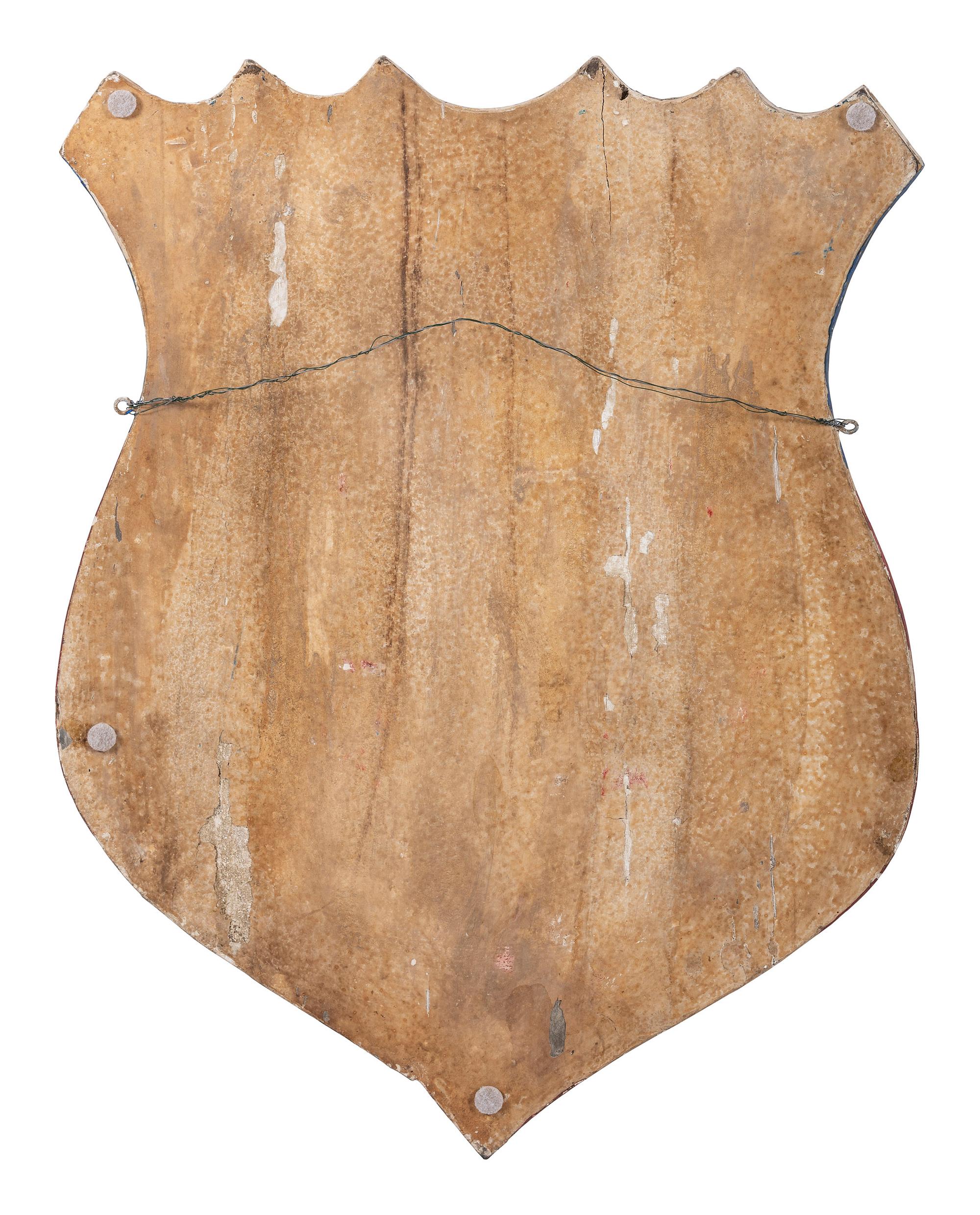 A Folk Art Carved and Painted Shield Form Flag