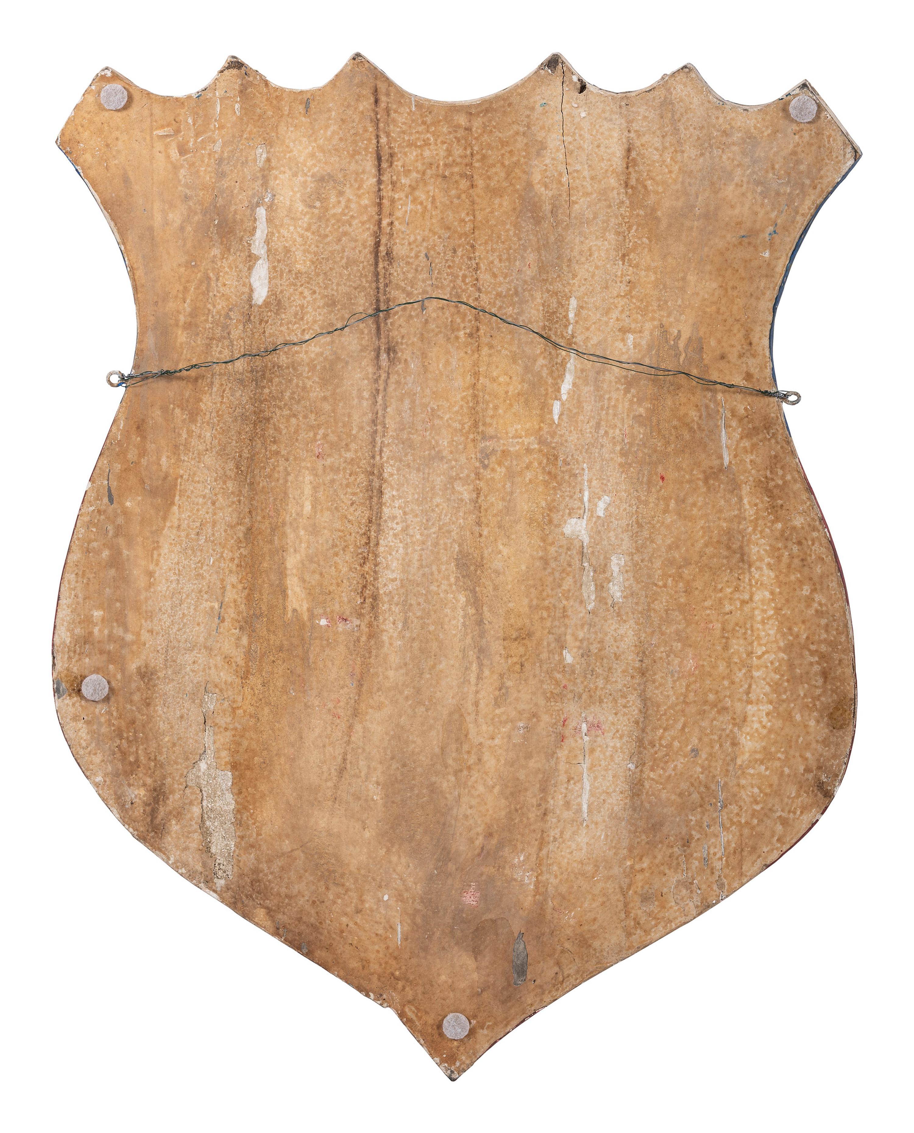 A Folk Art Carved and Painted Shield Form Flag