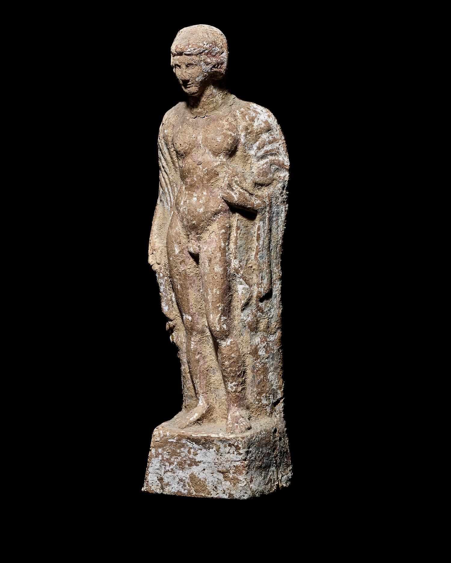 A Boeotian Terracotta Standing Youth with a Cock