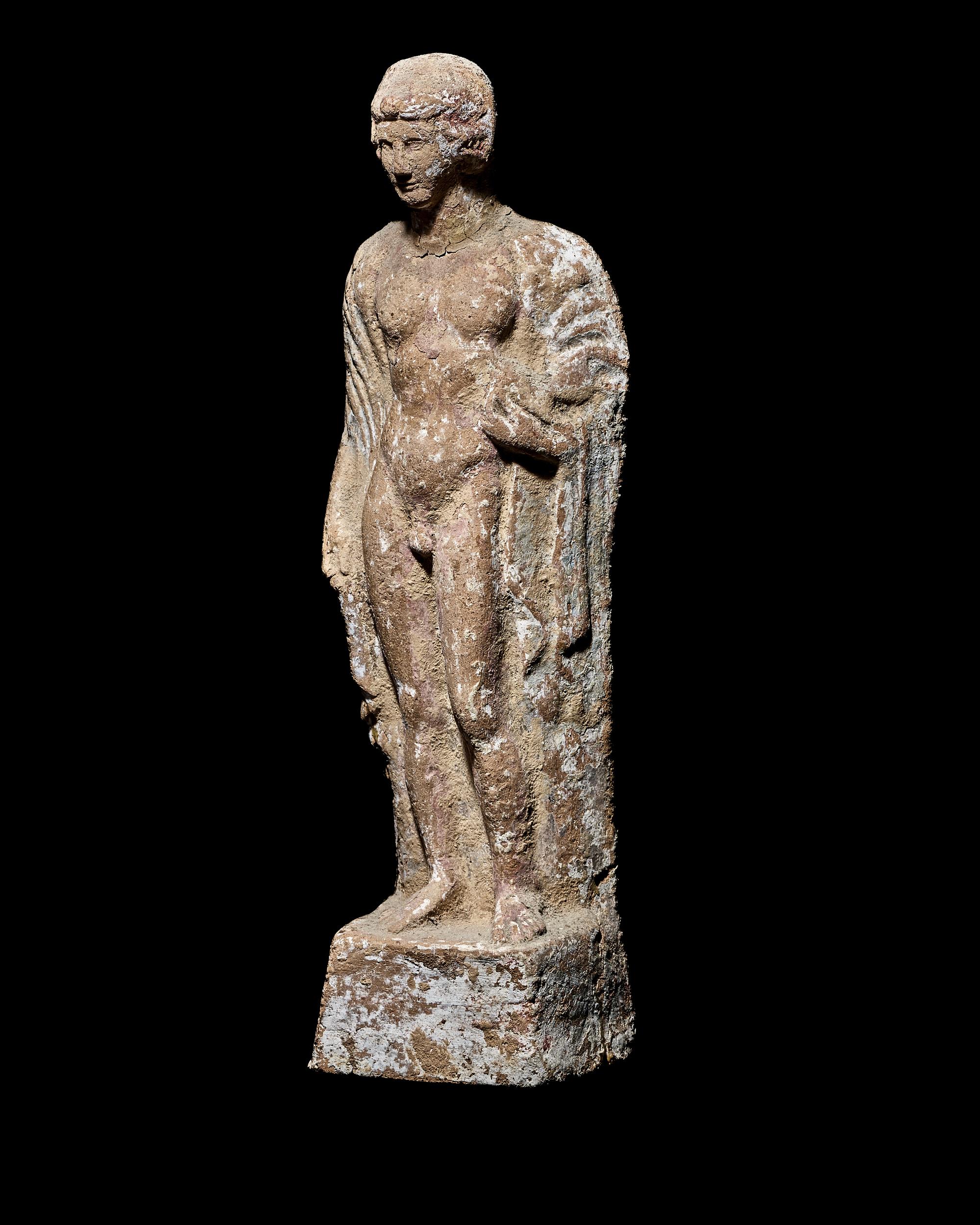 A Boeotian Terracotta Standing Youth with a Cock