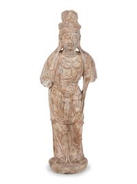 A Chinese Carved Stone Standing Guanyin Figure with Remnants of Polychrome Decoration