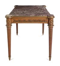 A Louis XVI Style Gilt Bronze Mounted Mahogany Marble-Top Center Table