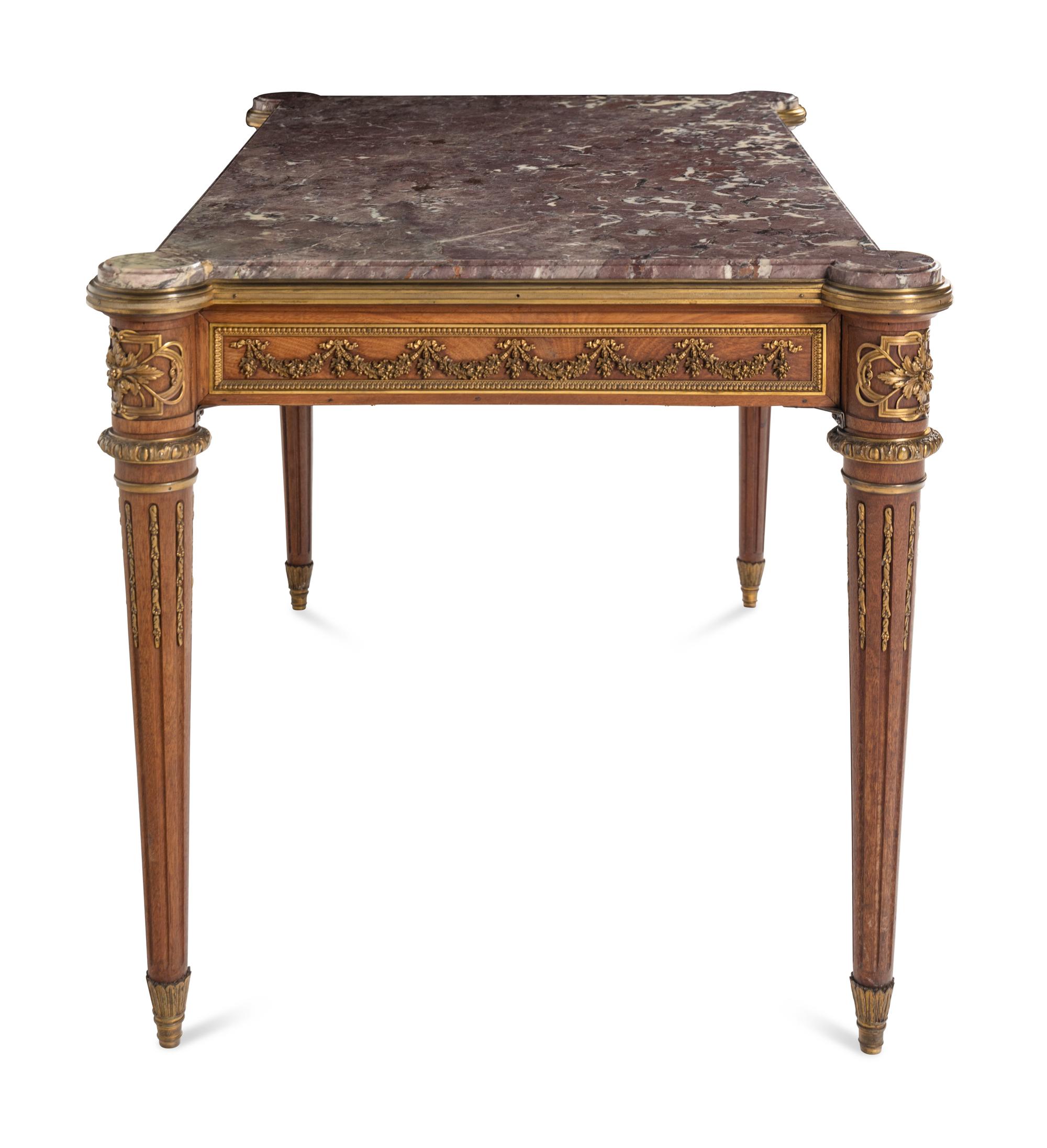 A Louis XVI Style Gilt Bronze Mounted Mahogany Marble-Top Center Table