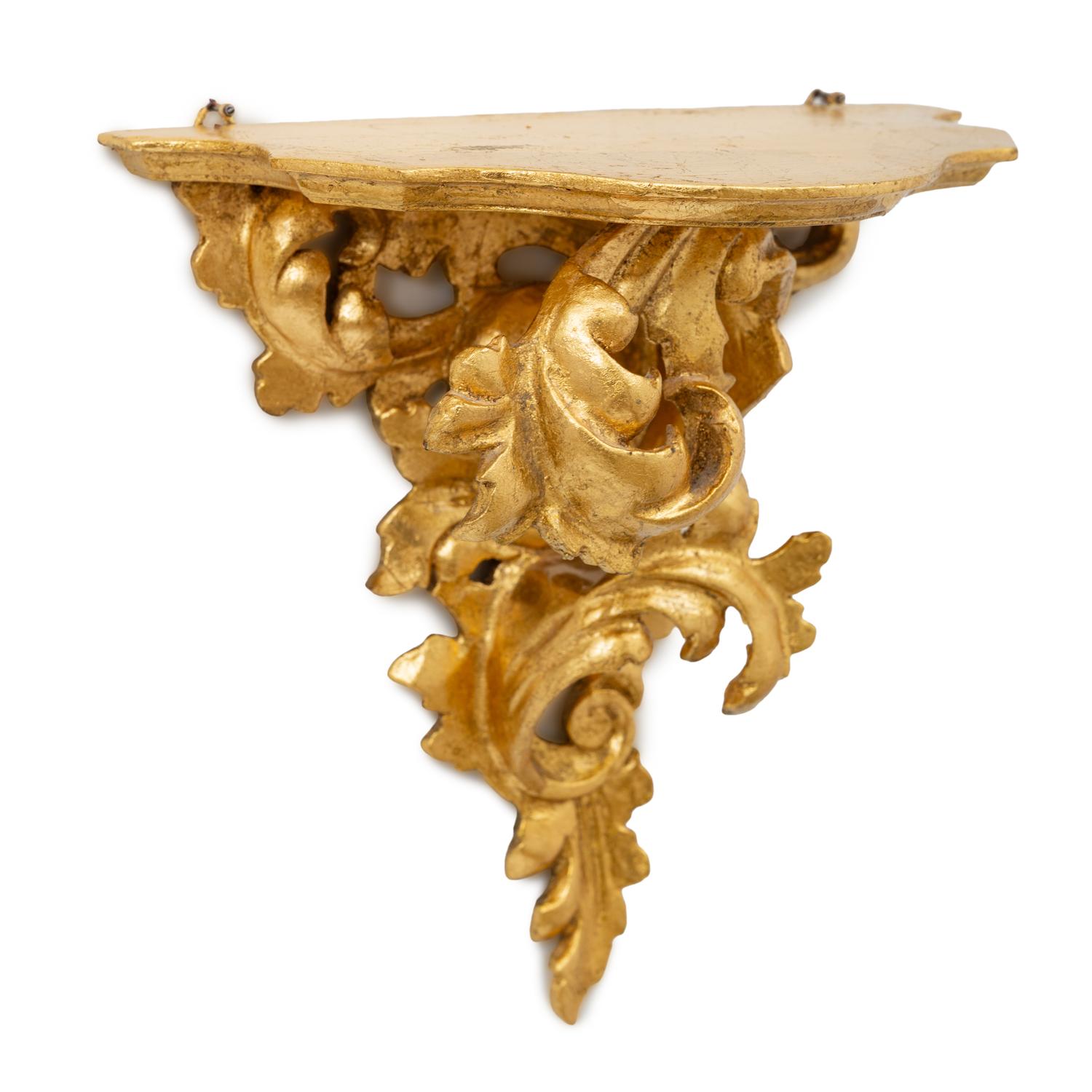 An Italian Rococo Style Carved Giltwood Oval Mirror and a Pair of Wall Brackets