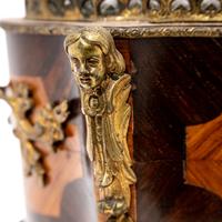 A French Porcelain and Gilt Bronze Mounted Kingwood Jardinière