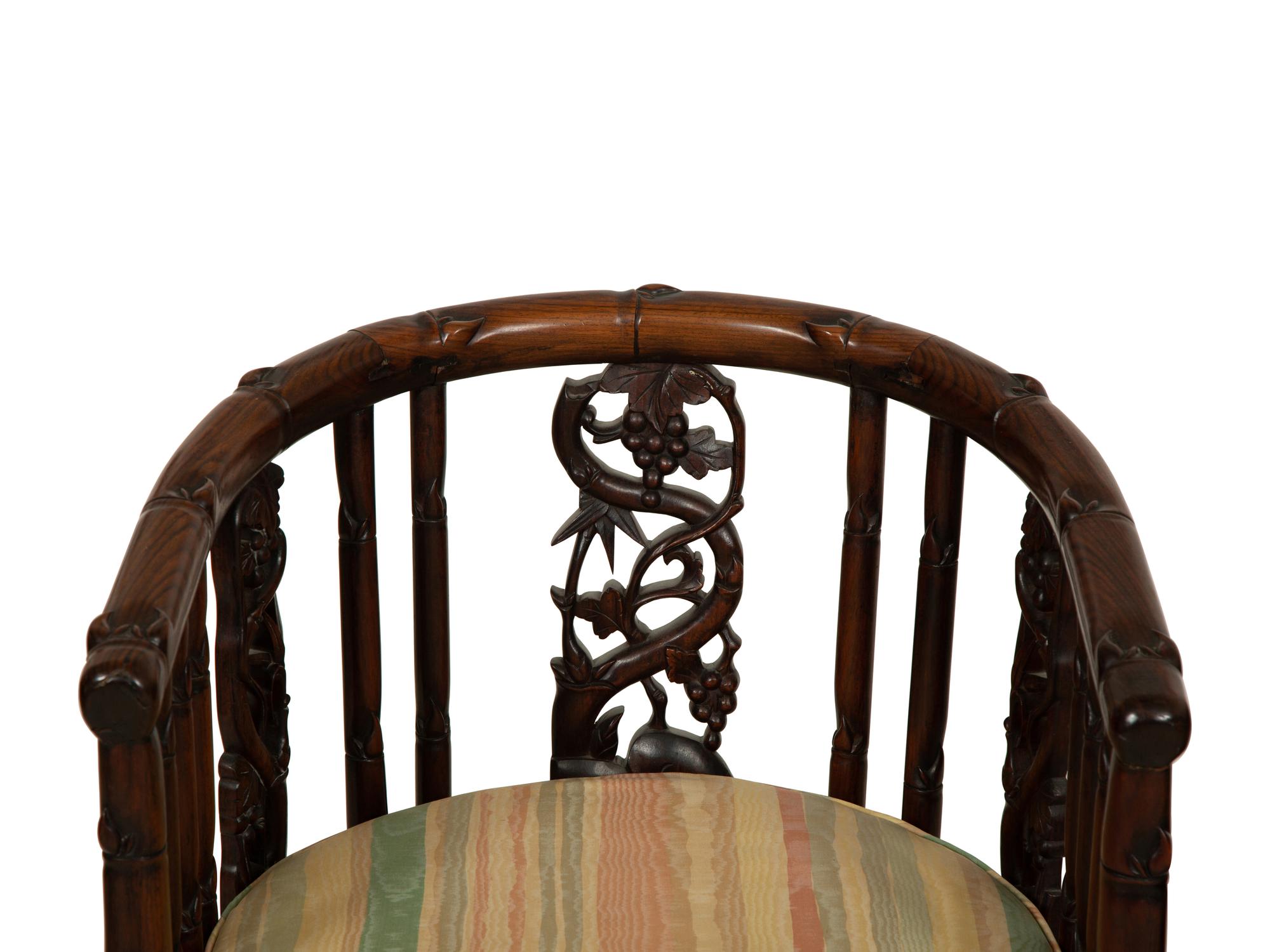A Pair of Chinese Hongmu Horseshoe Back Carved Armchairs