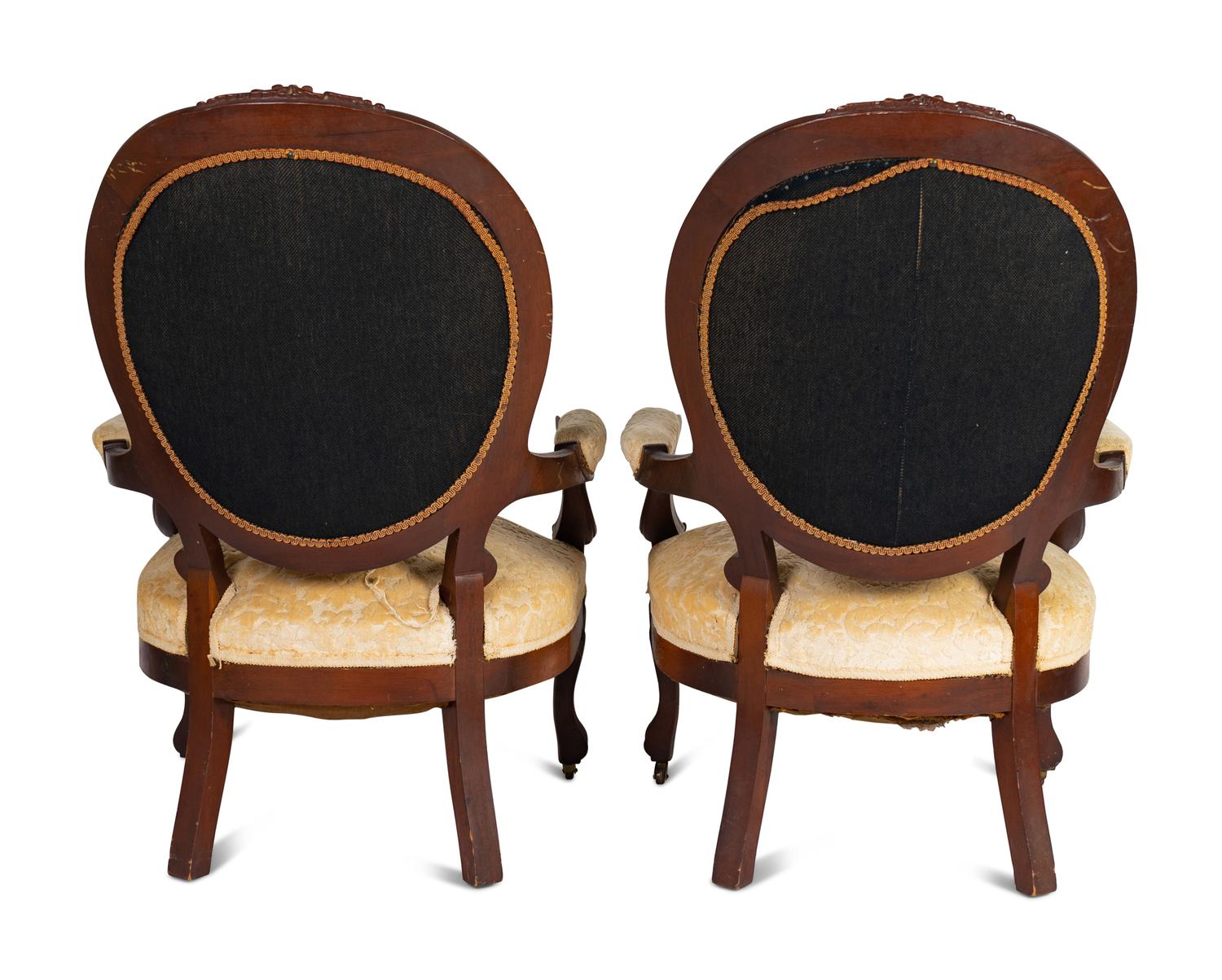 A Pair of Rococo Revival Carved Walnut Fauteuils