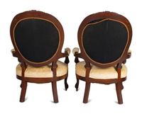 A Pair of Rococo Revival Carved Walnut Fauteuils