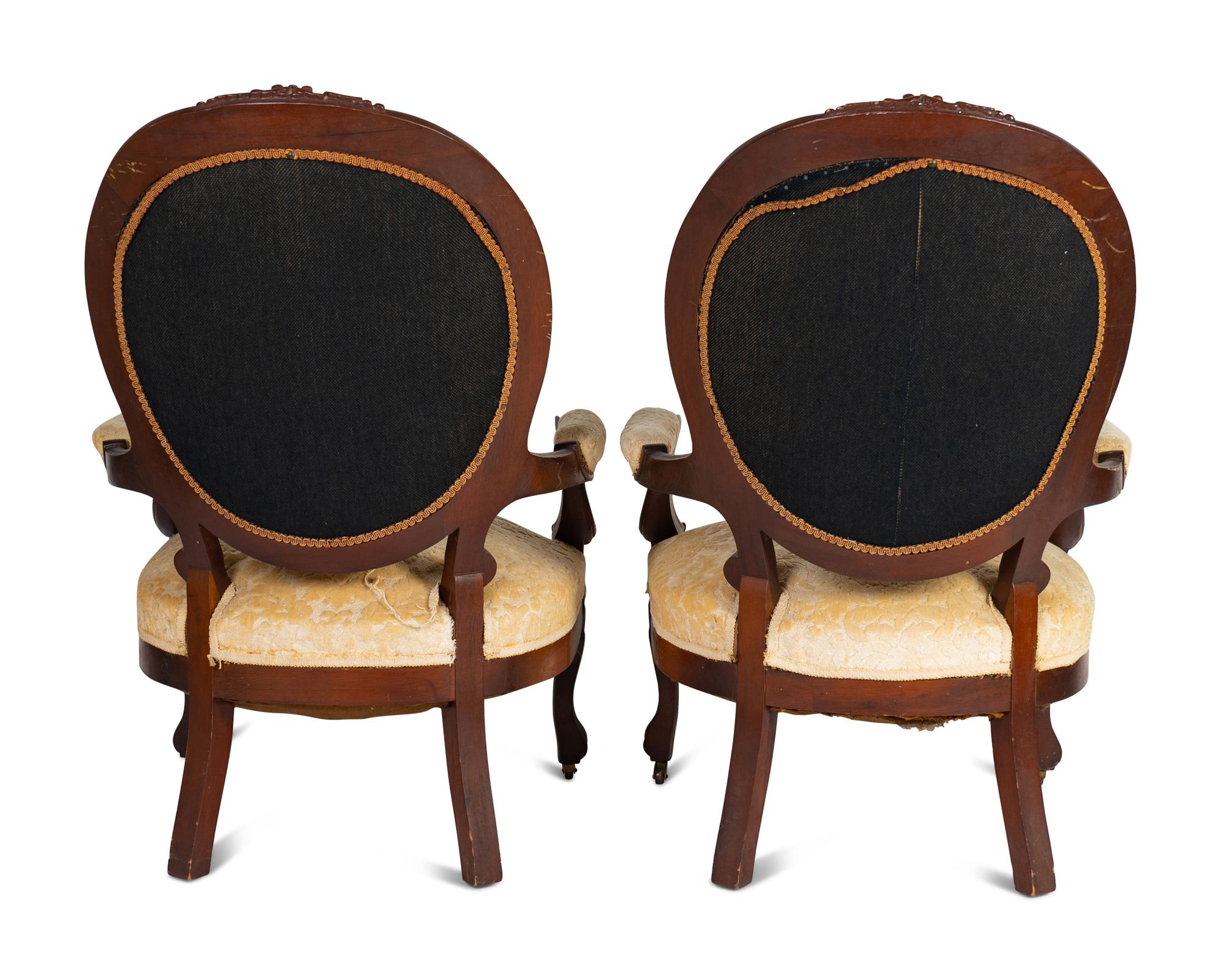 A Pair of Rococo Revival Carved Walnut Fauteuils
