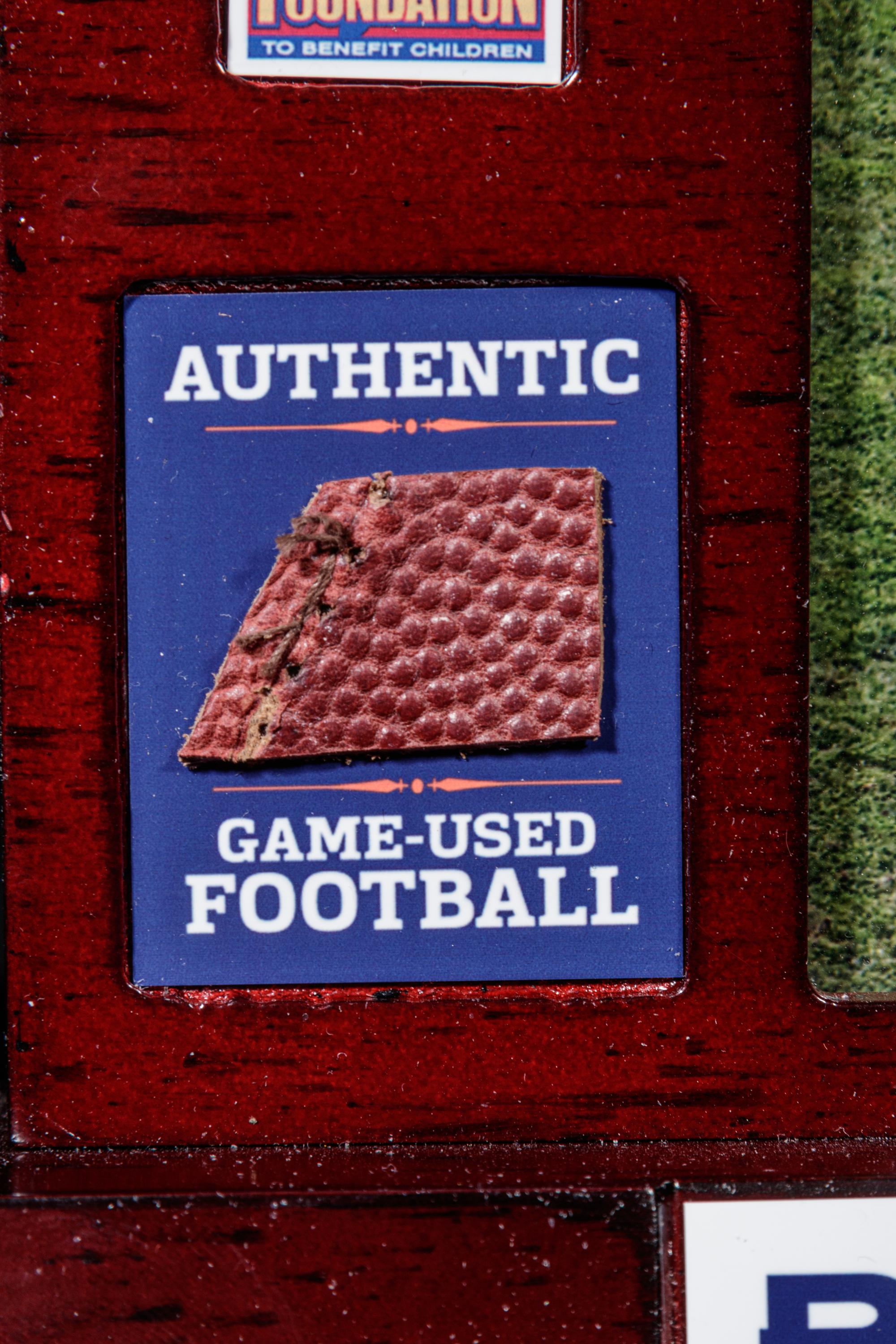 A Peyton Manning Signed Photograph and Game Used Football Fragment (Fanatics Authentic),