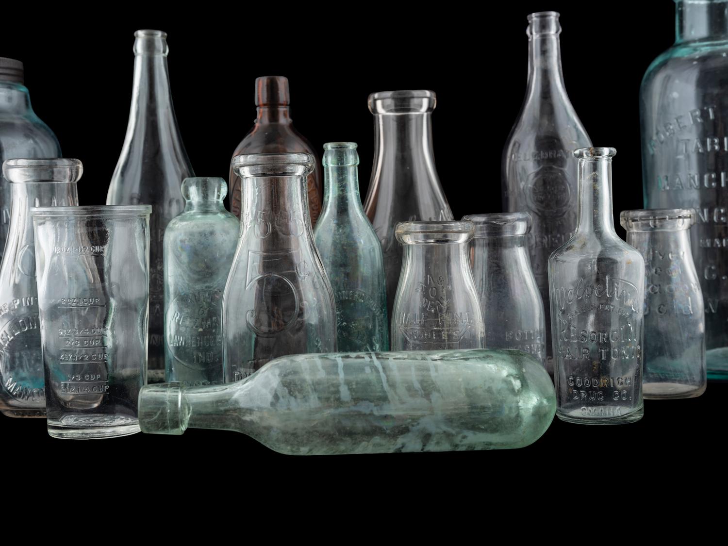 Sixteen Glass Advertising Bottles