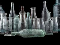 Sixteen Glass Advertising Bottles