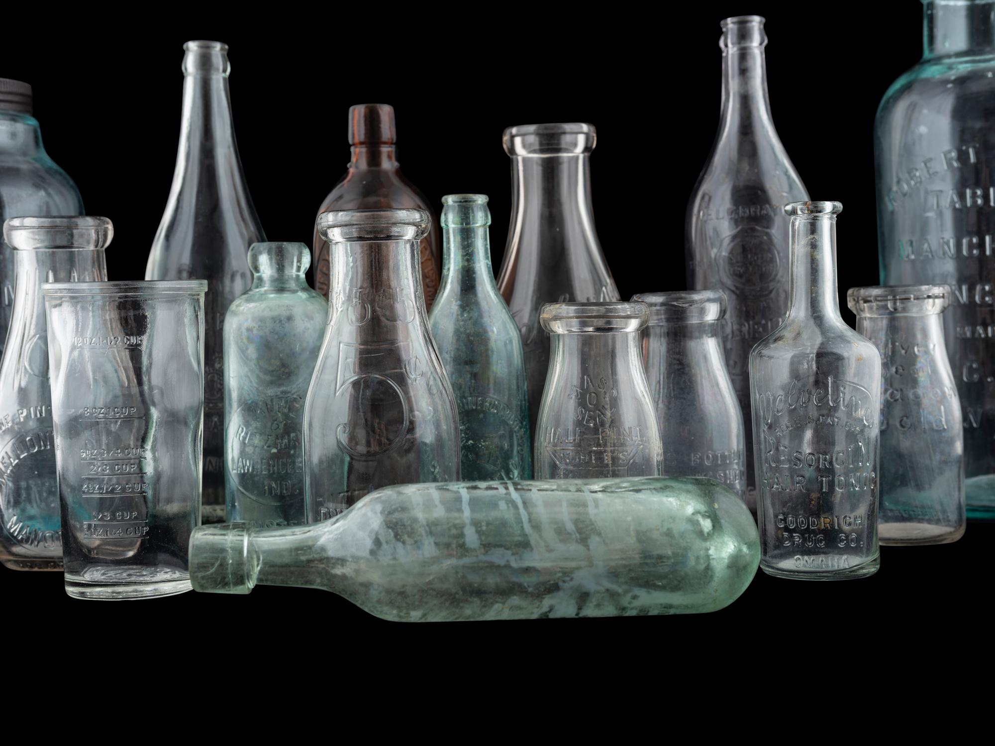 Sixteen Glass Advertising Bottles