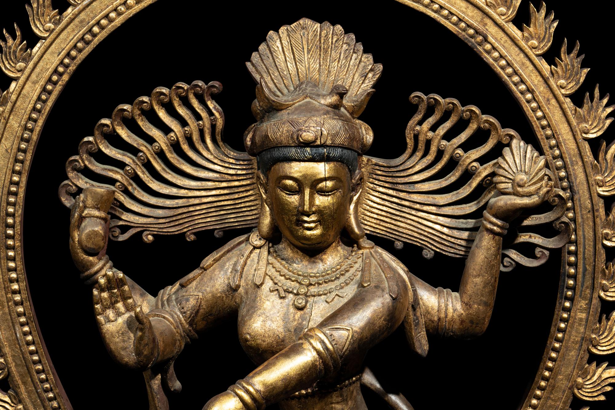 A Large Gilt and Red Lacquered Wood Figure of a Dancing Deity