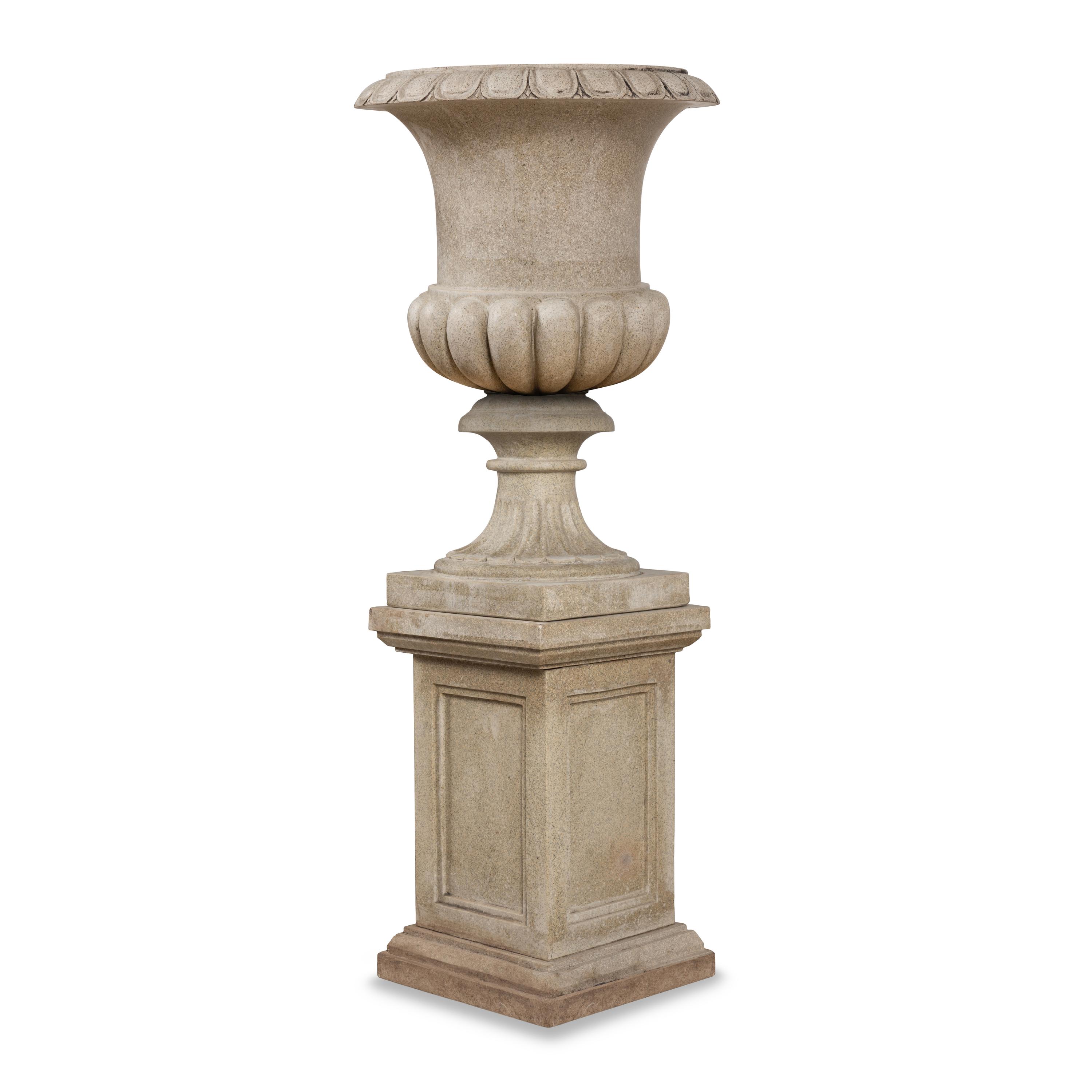A Pair of Carved Granite Urns and Plinths