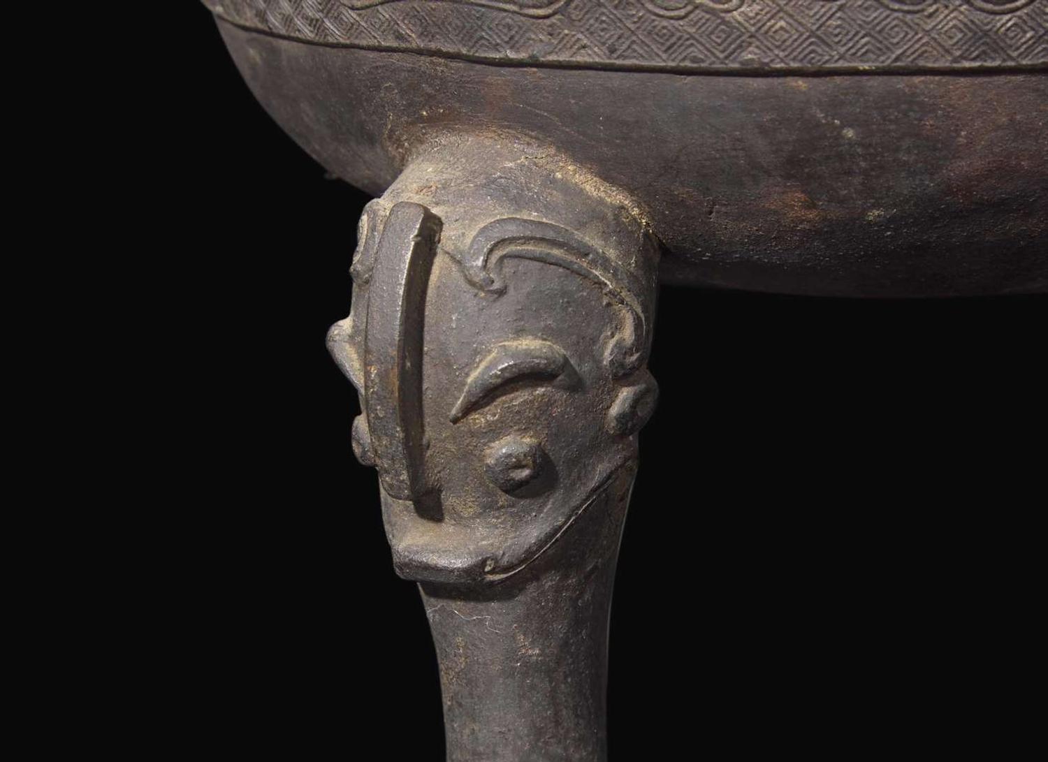 A large Chinese patinated bronze archaistic tripod censer, Ding, and wood cover, The Bronze 17th/18th Century or Earlier 清 青銅鼎式爐