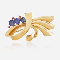 A 14K Yellow Gold, Sapphire, and Rubies Brooch Reflections By Trabert & Hoeffer Mauboussin