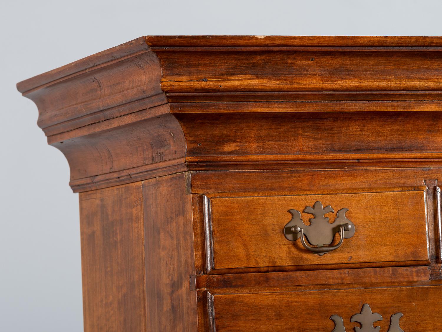 A Queen Anne Shell-Carved and Figured Maple Flat-Top High Chest of Drawers